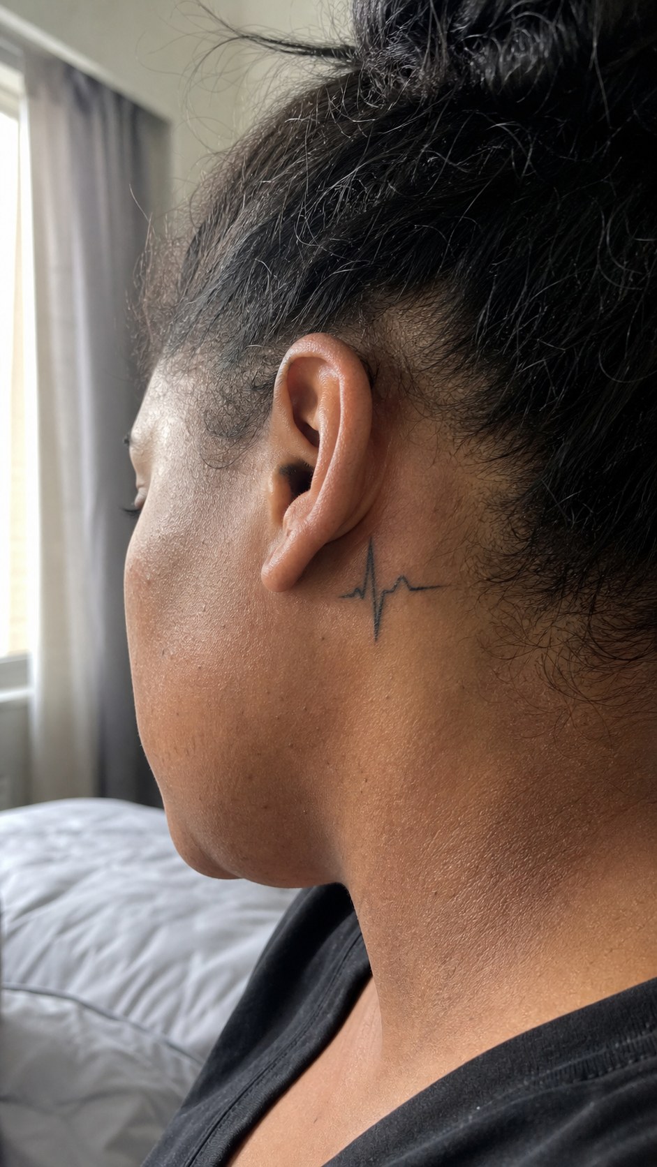 38 Creative Tattoo Ideas for Women 21 Healed heartbeat line tattoo on a adult woman's behind the ear, photographed in a natural waist-height candid close-up — study 1