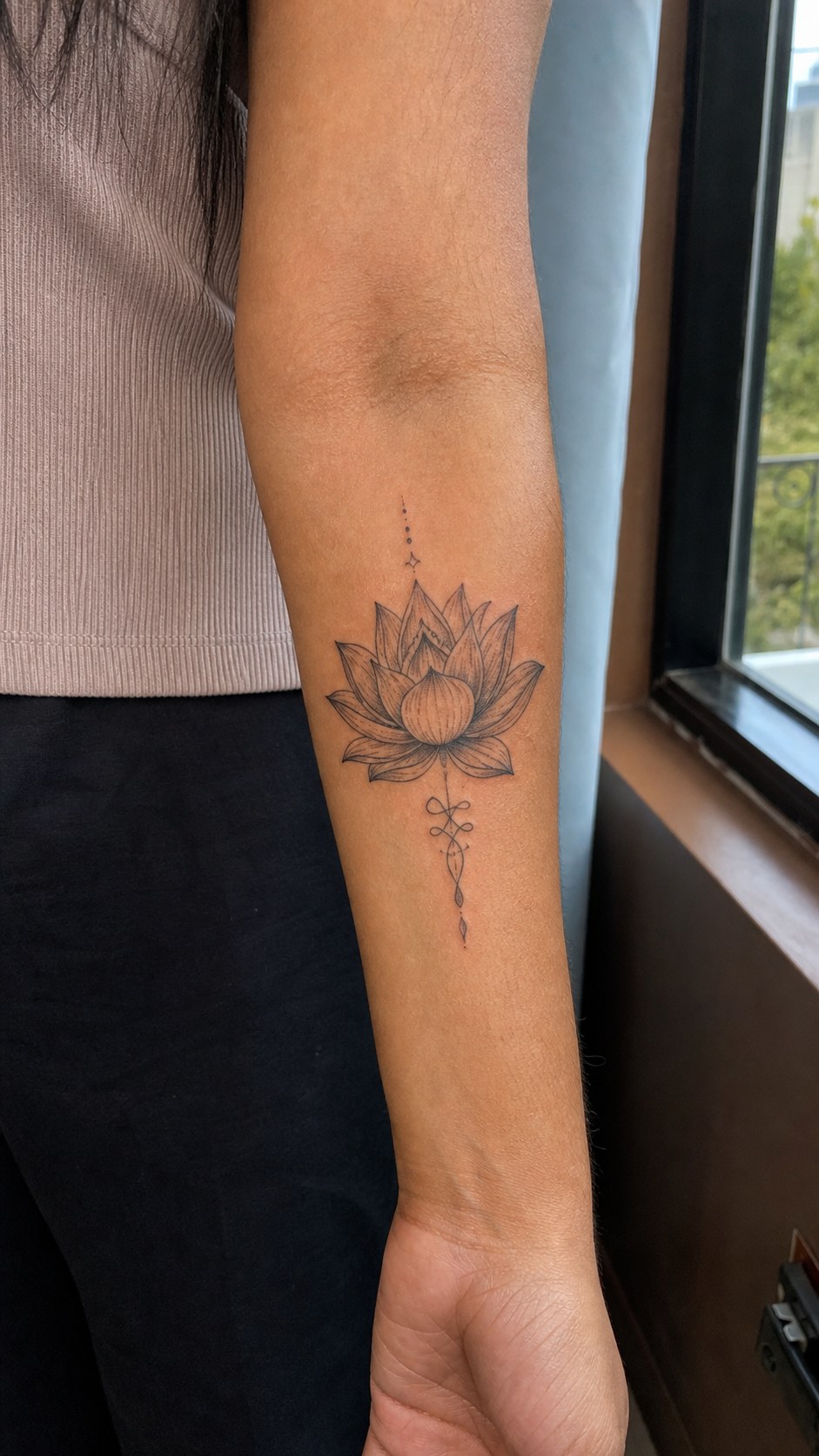 38 Creative Tattoo Ideas for Women 32 Healed lotus flower tattoo on a adult woman's inner forearm, photographed in a natural slightly elevated close view — study 1