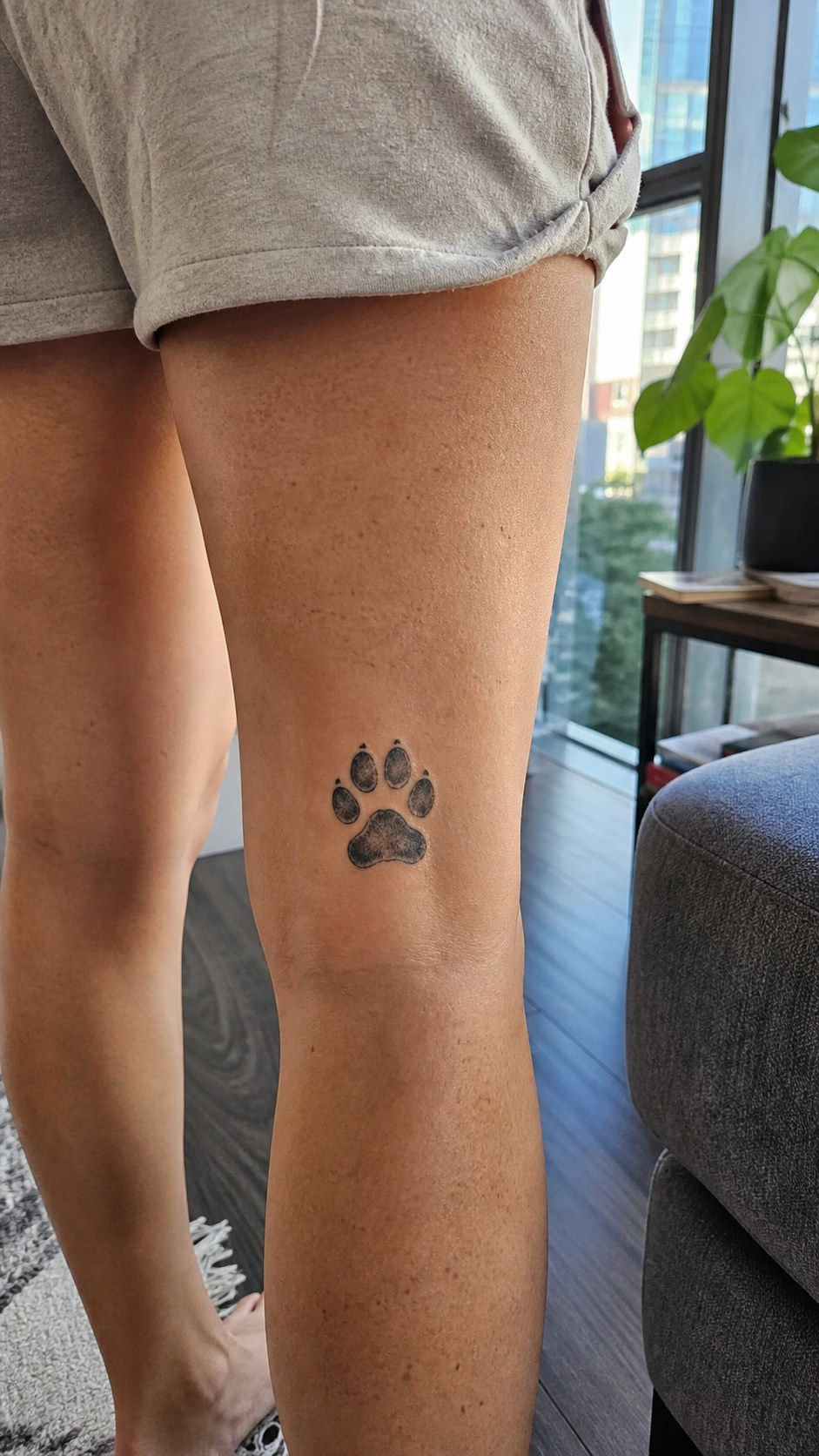 38 Creative Tattoo Ideas for Women 34 Healed paw print tattoo on a adult woman's outer calf, photographed in a natural waist-height candid close-up — study 1