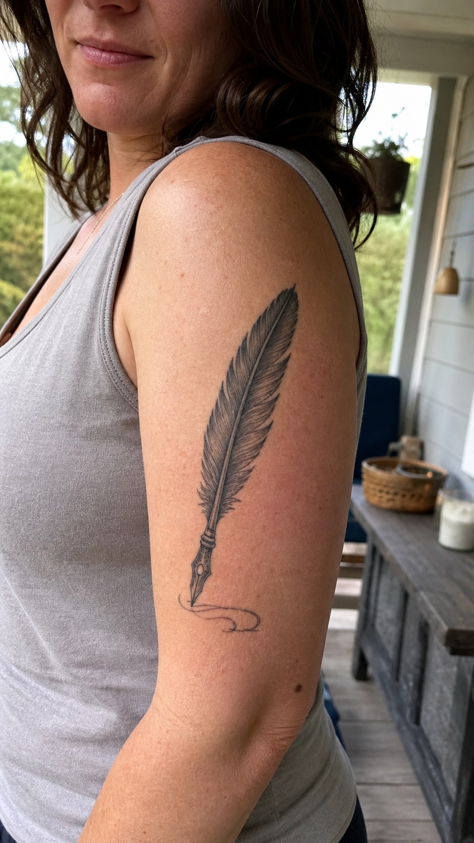 38 Creative Tattoo Ideas for Women 35 Healed feather quill tattoo on a adult woman's outer upper arm, photographed in a natural waist-height candid close-up — study 1