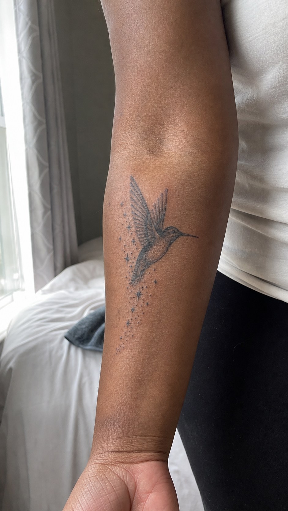38 Creative Tattoo Ideas for Women 41 Healed hummingbird tattoo on a adult woman's inner forearm, photographed in a natural waist-height candid close-up — study 1