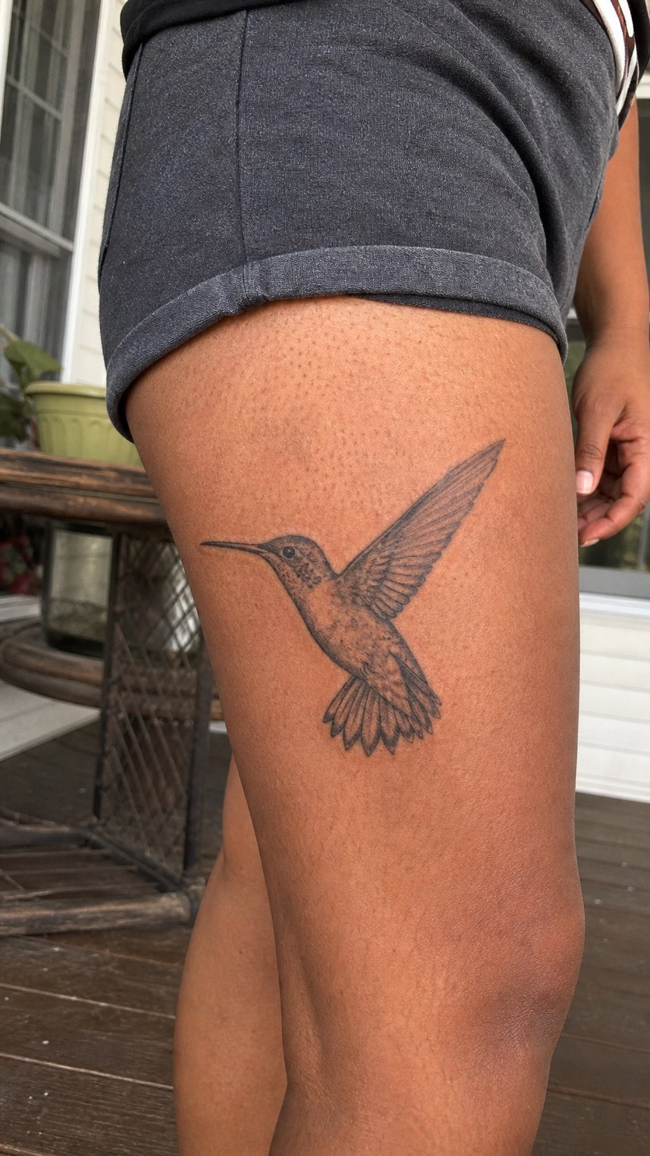 38 Creative Tattoo Ideas for Women 42 Healed hummingbird tattoo on a adult woman's outer thigh, photographed in a natural relaxed documentary crop — study 2