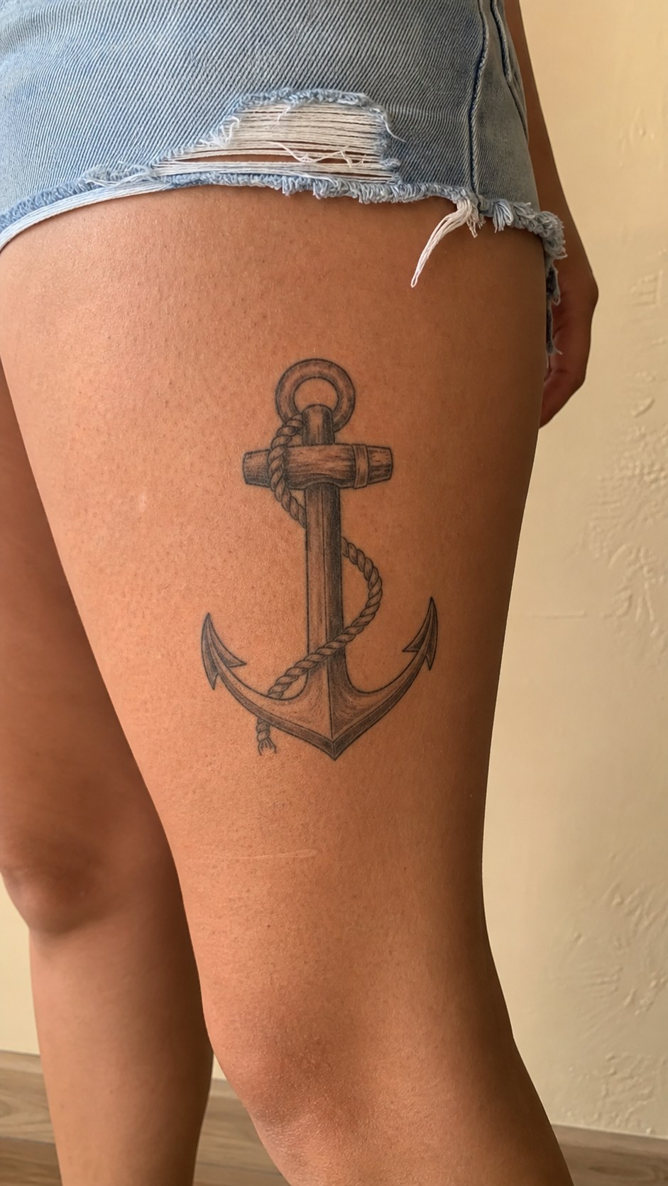 38 Creative Tattoo Ideas for Women 44 Healed anchor with rope tattoo on a adult woman's outer thigh, photographed in a natural casual close three-quarter view — study 2