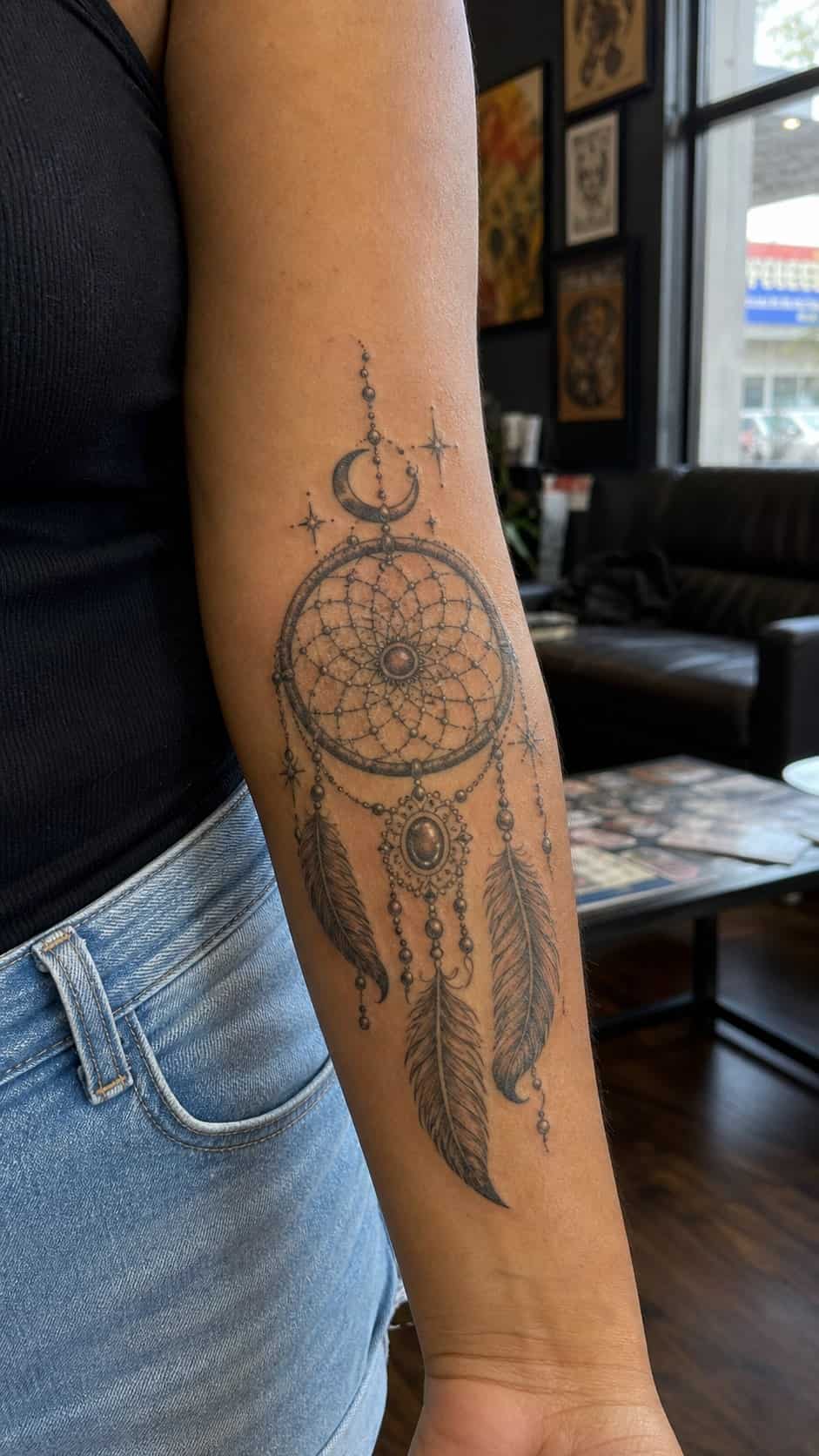 Healed mystical dreamcatcher tattoo on a adult woman's inner forearm, photographed in a natural waist-height candid close-up — study 2