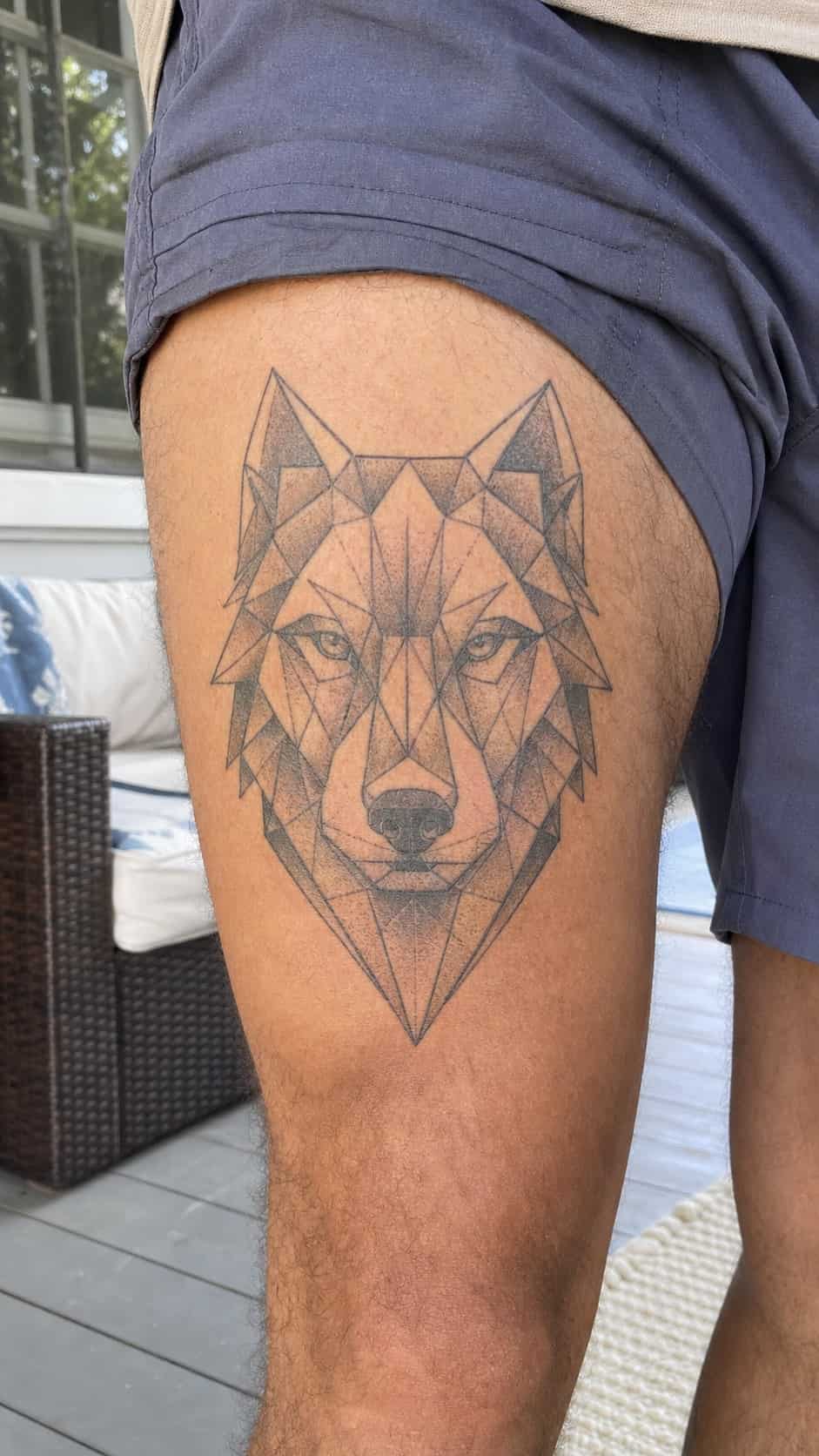 Feeling Bold? Try These 25 Killer Thigh Tattoo Ideas for Men 8 Healed geometric wolf head tattoo on a adult man's outer thigh, photographed in a natural straight-on close view, a touch off-center — study 3