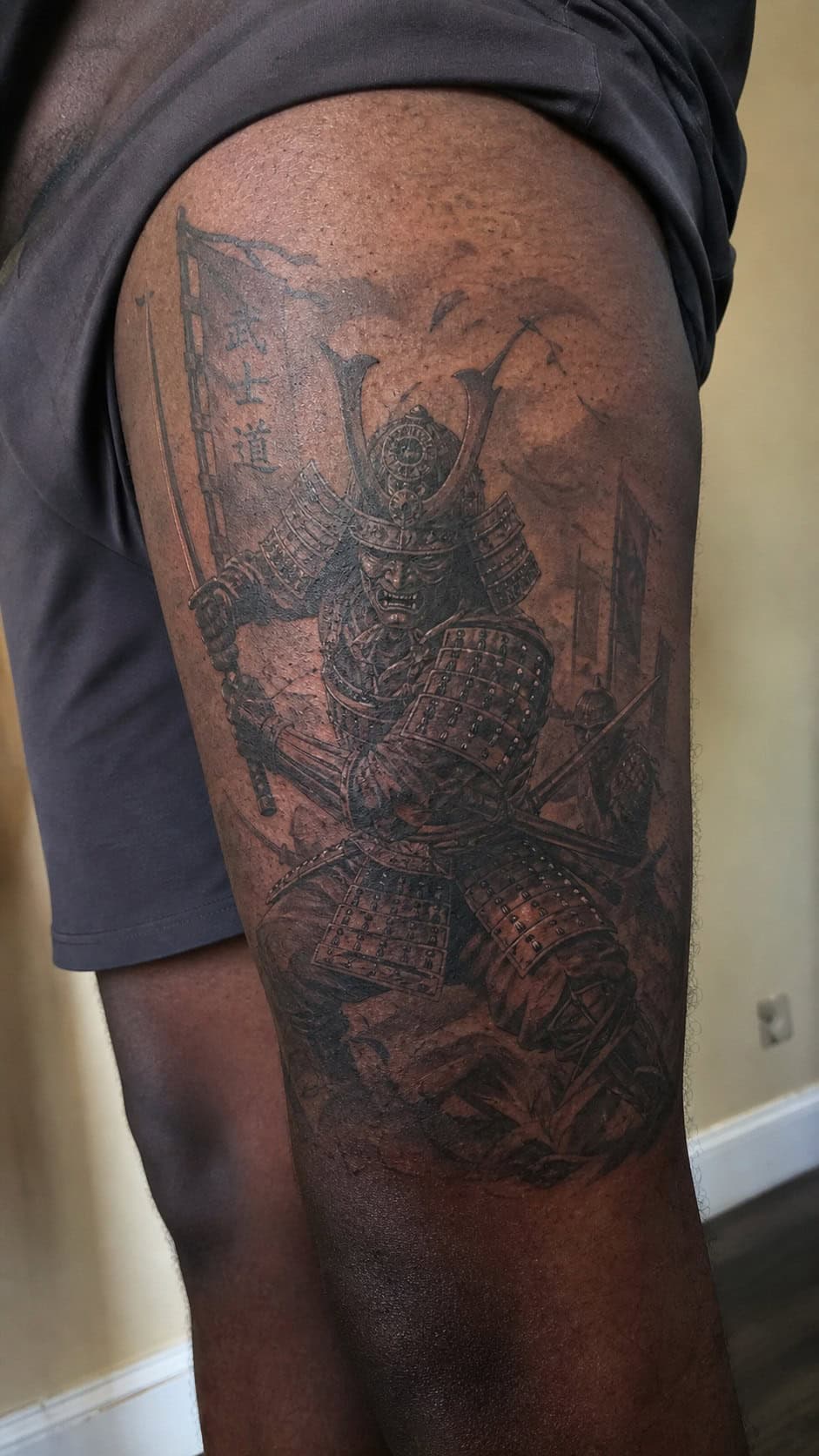 Feeling Bold? Try These 25 Killer Thigh Tattoo Ideas for Men 12 Healed samurai warrior in battle tattoo on a adult man's outer thigh, photographed in a natural straight-on close view, a touch — study 2