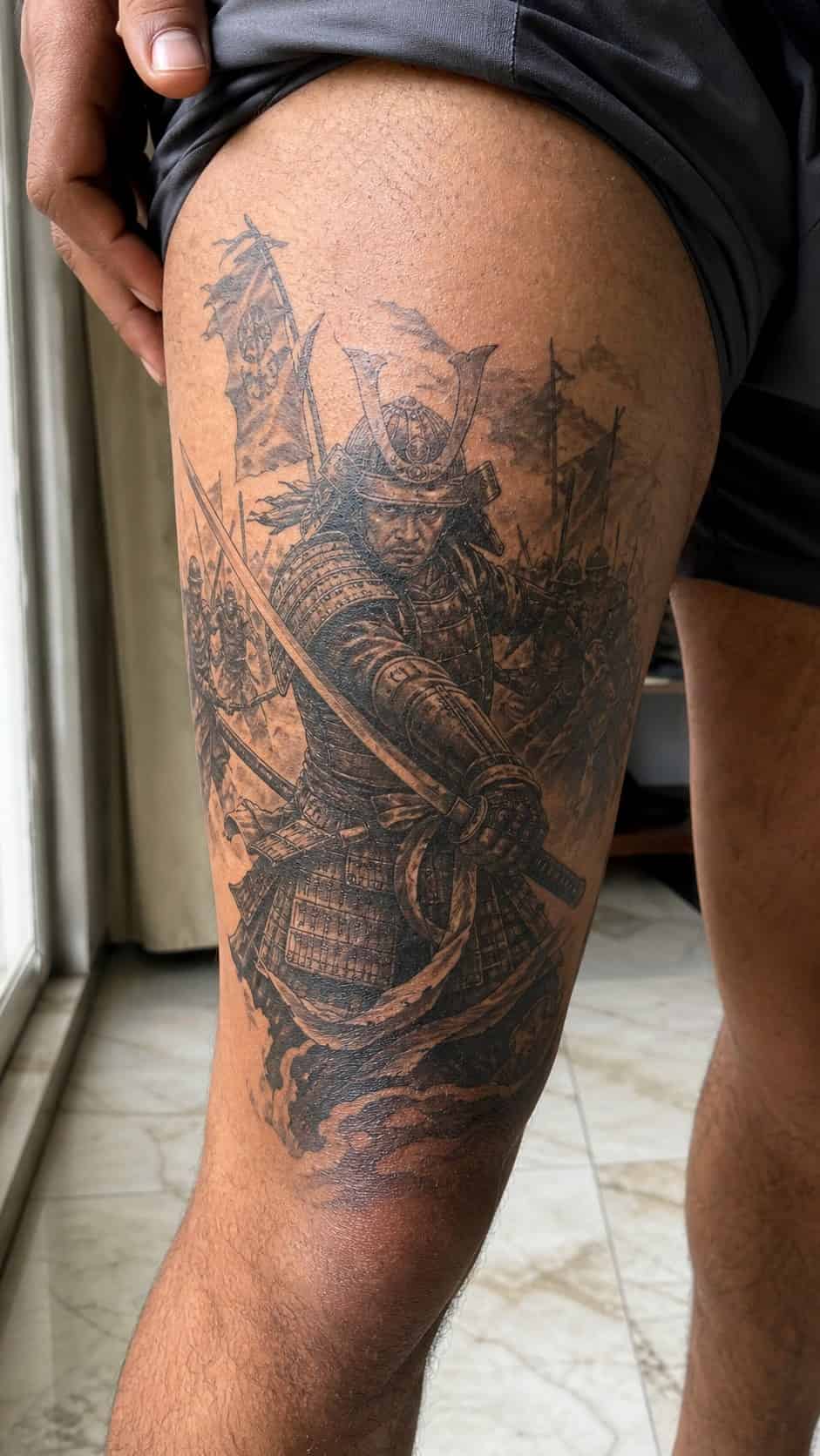 Feeling Bold? Try These 25 Killer Thigh Tattoo Ideas for Men 13 Healed samurai warrior in battle tattoo on a adult man's outer thigh, photographed in a natural gentle side angle that clearly shows — study 3