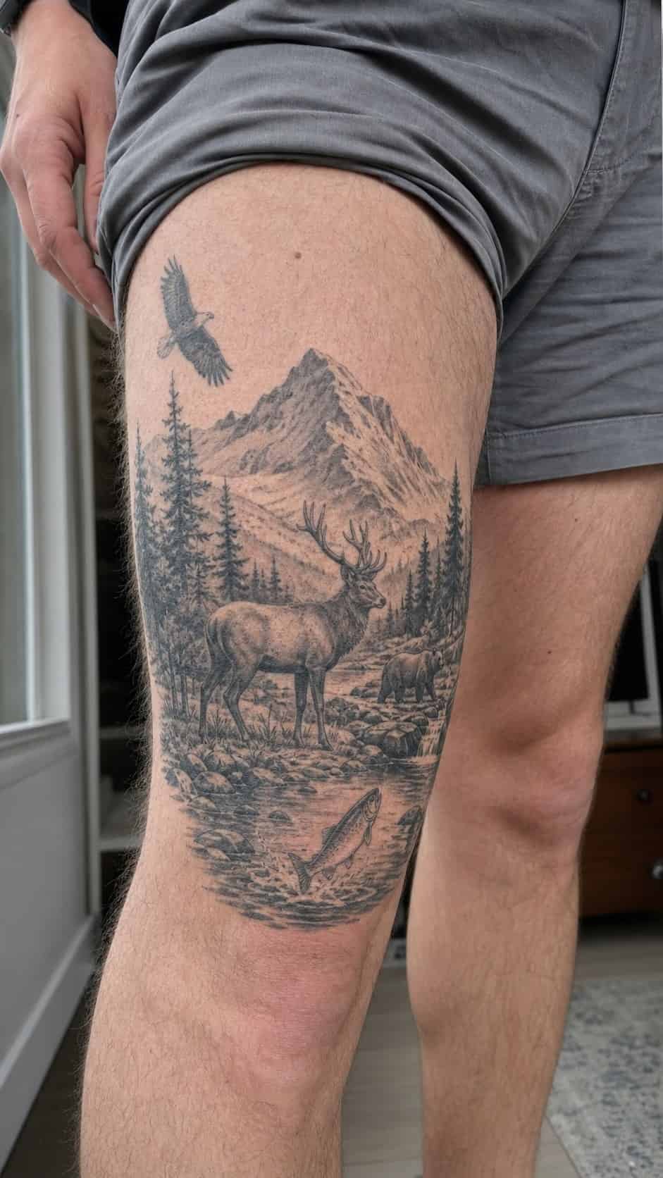 Feeling Bold? Try These 25 Killer Thigh Tattoo Ideas for Men 27 Healed wildlife scene tattoo on a adult man's outer thigh, photographed in a natural casual close three-quarter view — study 1