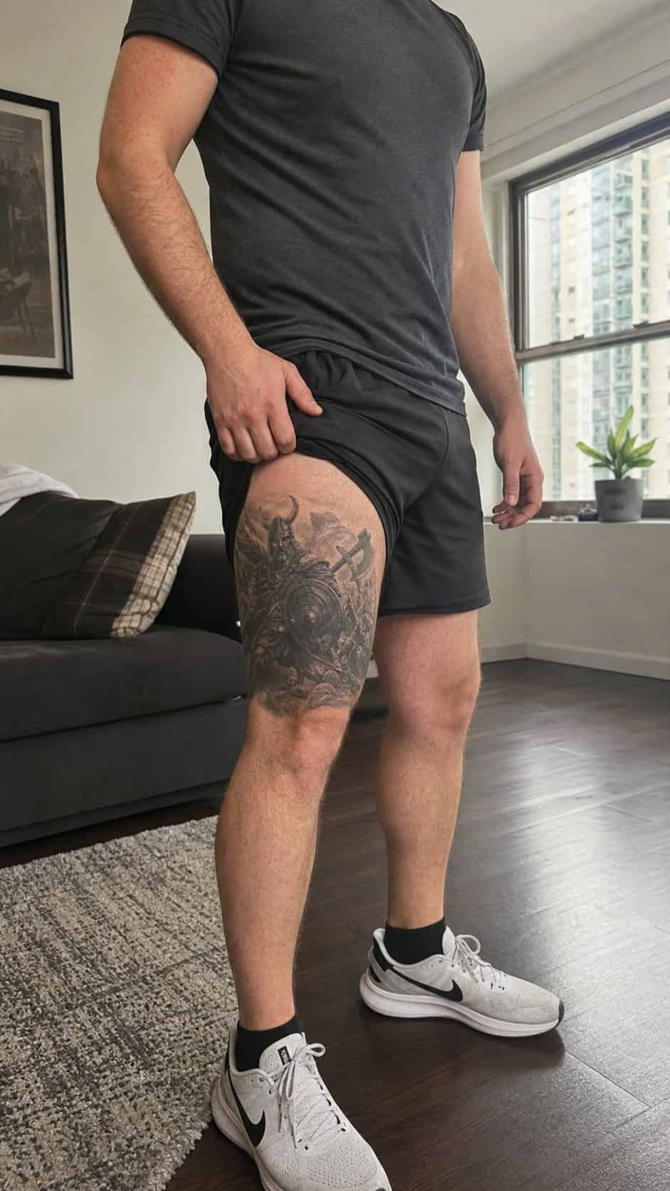 Feeling Bold? Try These 25 Killer Thigh Tattoo Ideas for Men 47 Healed viking warrior in battle tattoo on a adult man's outer thigh, photographed in a natural waist-height candid close-up — study 2
