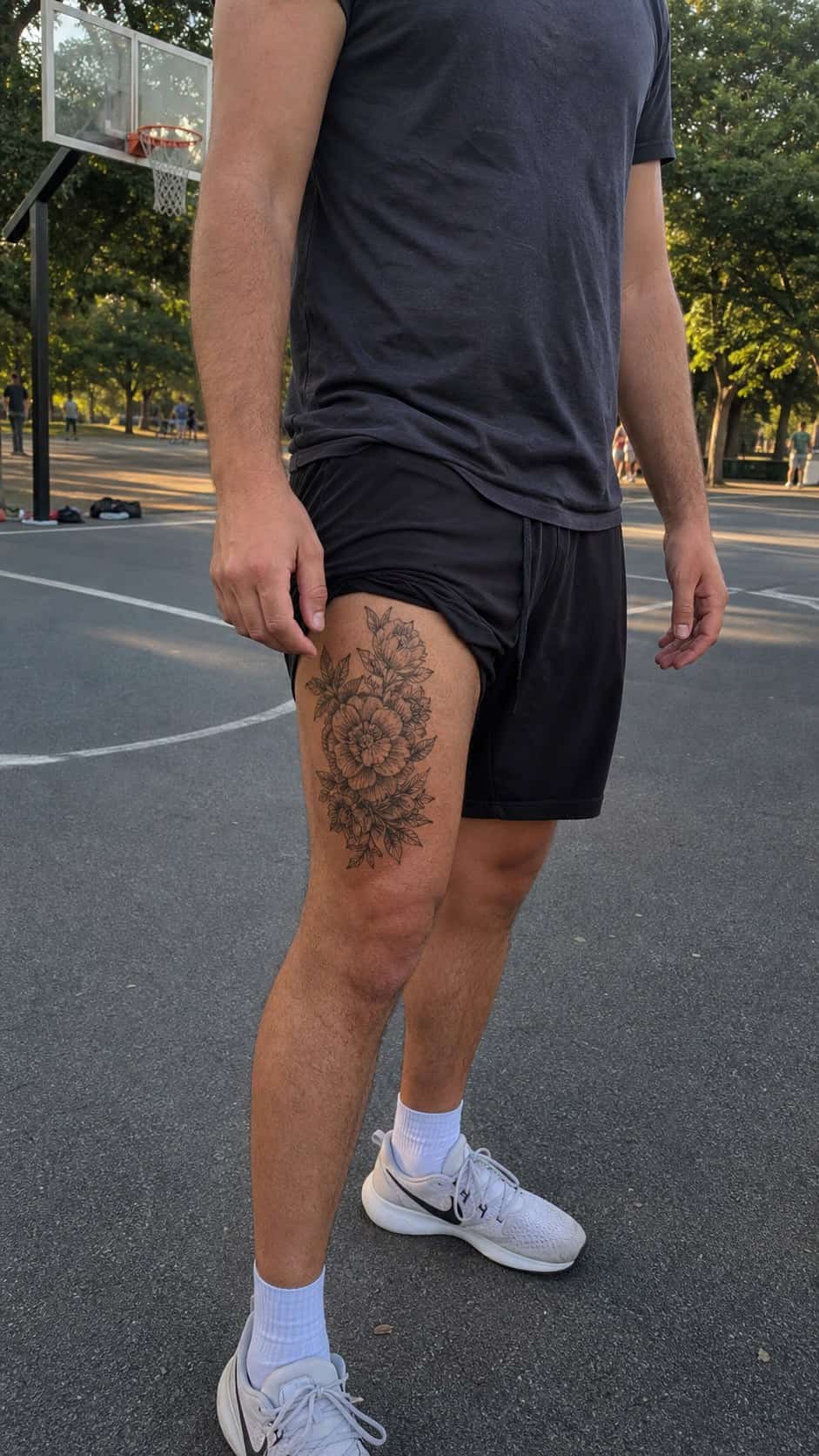 Feeling Bold? Try These 25 Killer Thigh Tattoo Ideas for Men 49 Healed detailed floral arrangement tattoo on a adult man's outer thigh, photographed in a natural relaxed documentary crop — study 1