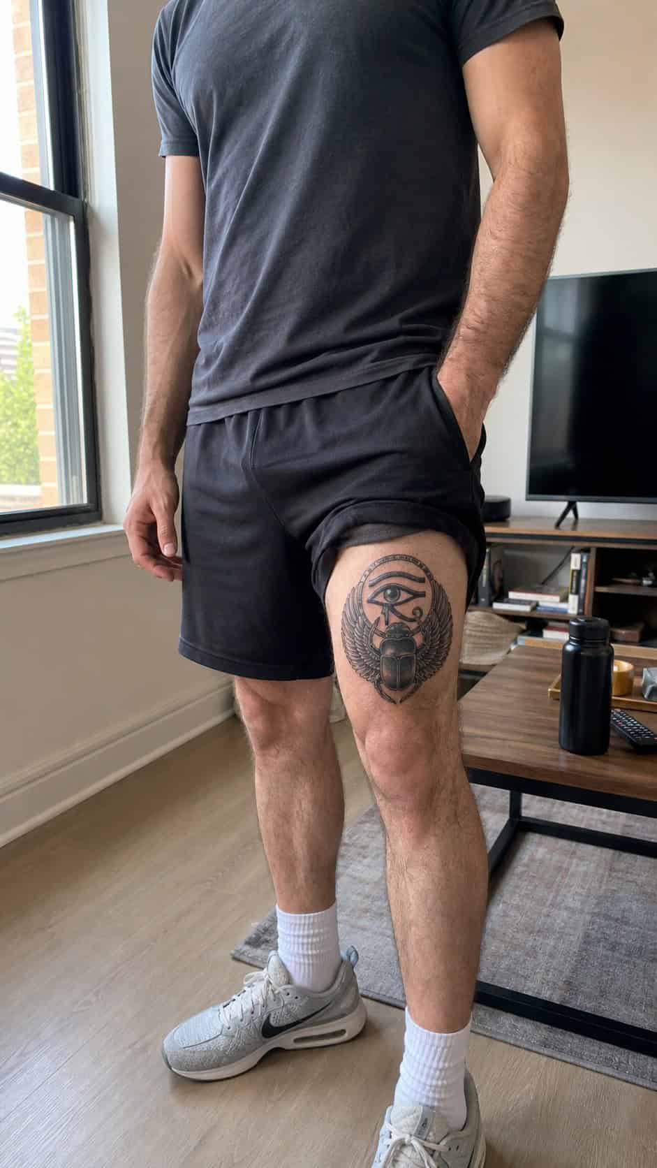 Feeling Bold? Try These 25 Killer Thigh Tattoo Ideas for Men 55 Healed ancient egyptian symbol tattoo on a adult man's outer thigh, photographed in a natural relaxed documentary crop — study 1