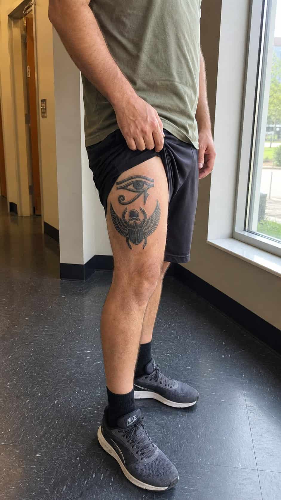 Feeling Bold? Try These 25 Killer Thigh Tattoo Ideas for Men 56 Healed ancient egyptian symbol tattoo on a adult man's outer thigh, photographed in a natural casual close three-quarter view — study 2