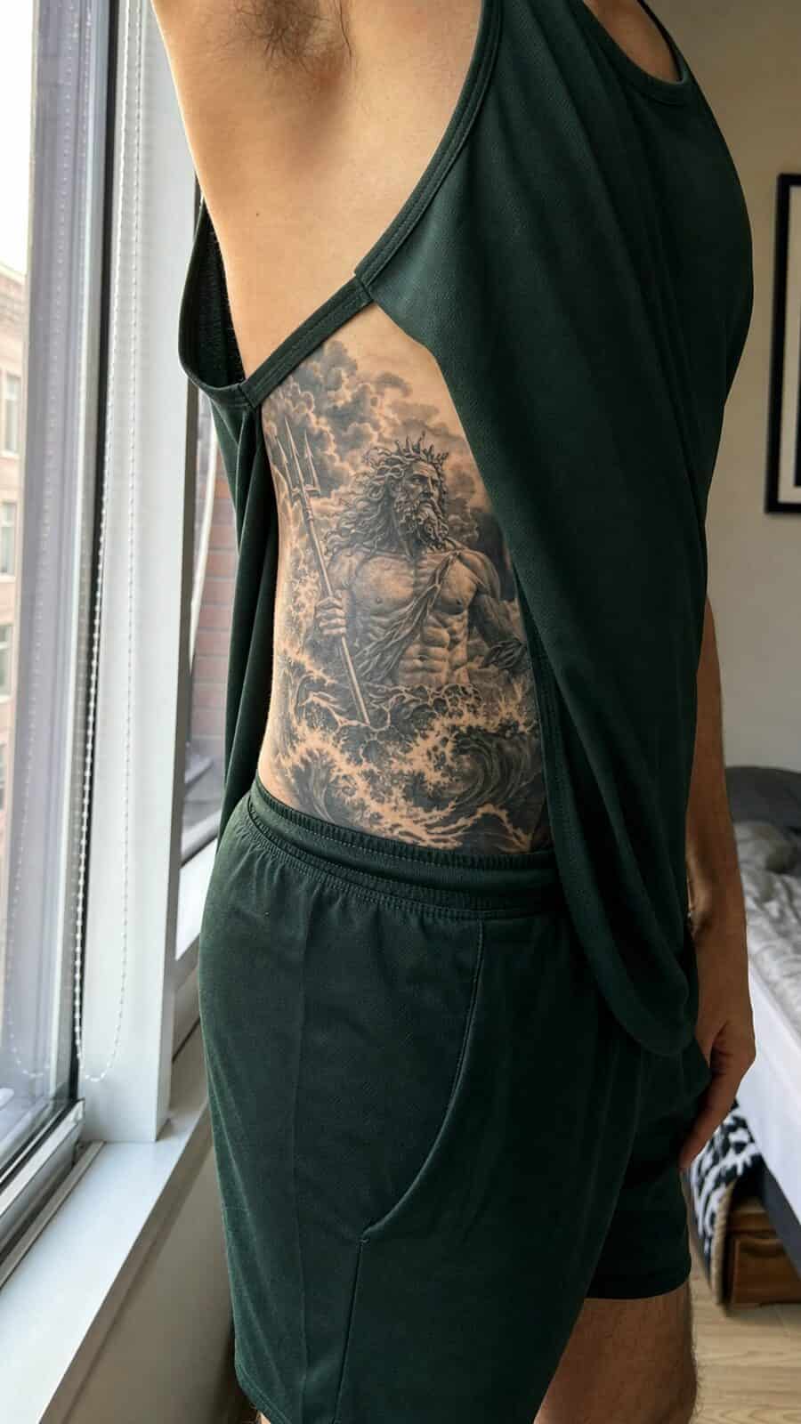 25 Rib Tattoos for Men Worth Considering 9 Healed greek god poseidon tattoo on a adult man's side ribs, photographed in a natural relaxed documentary crop — study 2