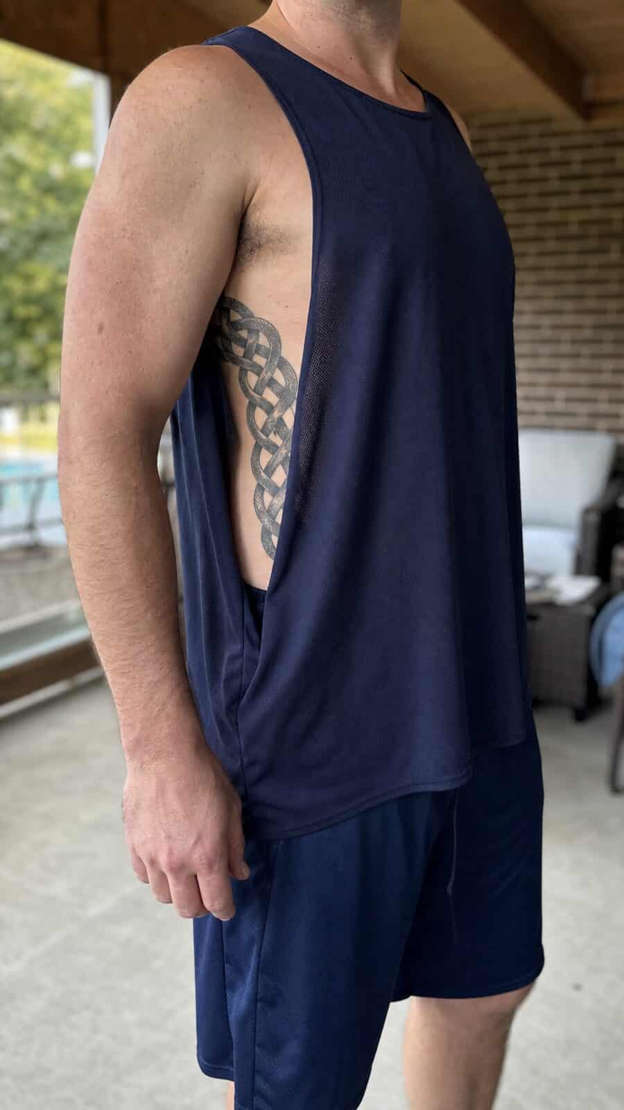 25 Rib Tattoos for Men Worth Considering 18 Healed celtic knot tattoo on a adult man's side ribs, photographed in a natural relaxed documentary crop — study 2