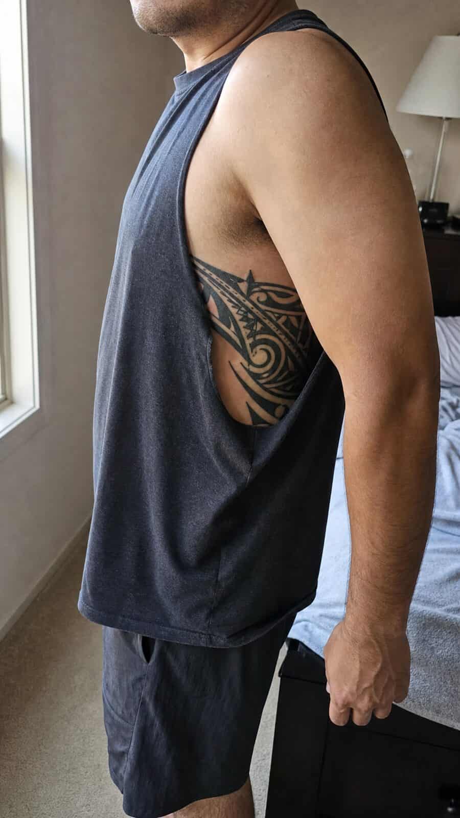 25 Rib Tattoos for Men Worth Considering 22 Healed tribal patterns tattoo on a adult man's side ribs, photographed in a natural straight-on close view, a touch off-center like a — study 2