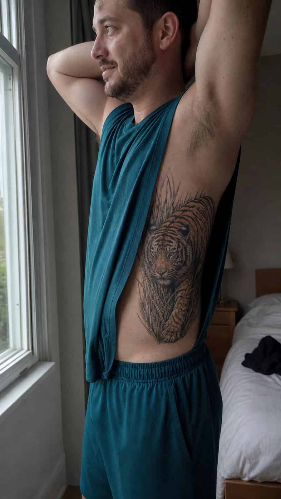 25 Rib Tattoos for Men Worth Considering 43 Healed realistic tiger tattoo on a adult man's side ribs, photographed in a natural gentle side angle that clearly shows how the ink — study 2