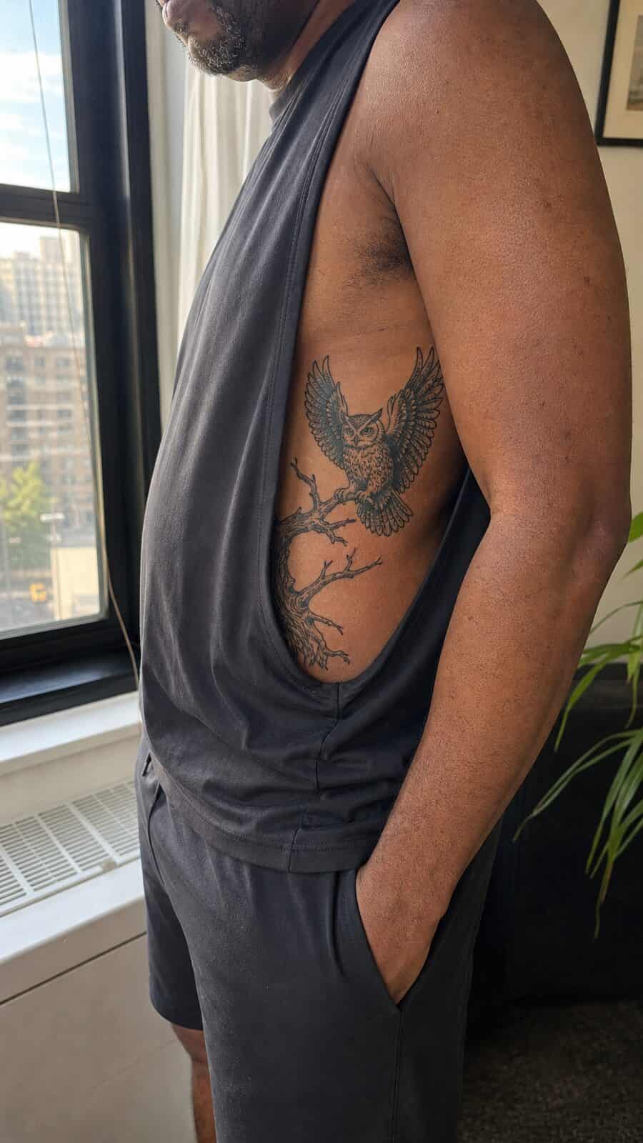 25 Rib Tattoos for Men Worth Considering 46 Healed mystical owl tattoo on a adult man's side ribs, photographed in a natural waist-height candid close-up — study 2