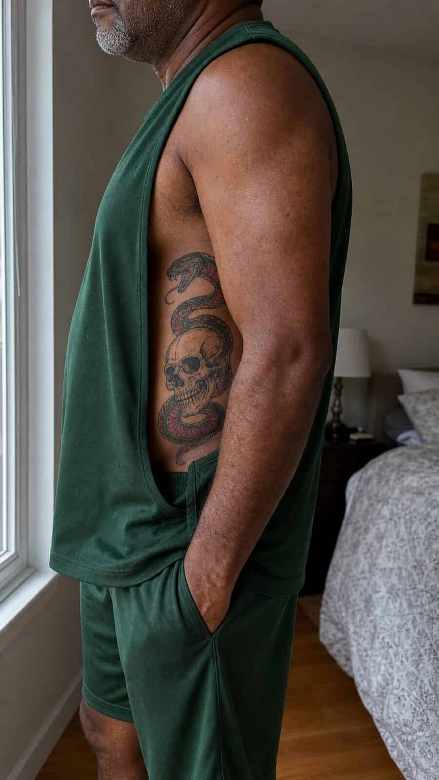 25 Rib Tattoos for Men Worth Considering 50 Healed serpent and skull tattoo on a adult man's side ribs, photographed in a natural relaxed documentary crop — study 2