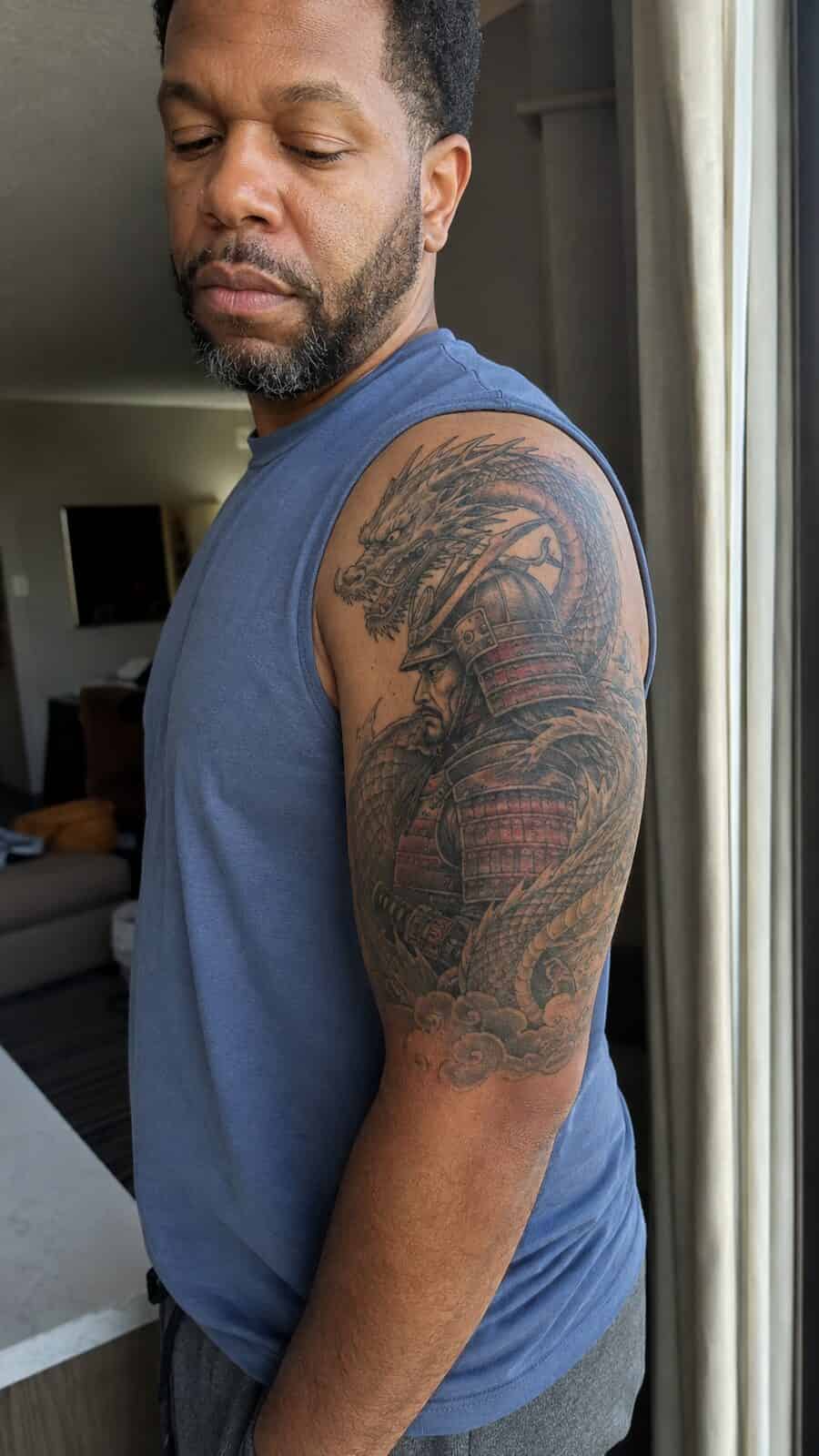 Unlock Your Next Ink: 25 Epic Upper Arm Tattoo Ideas for Men 49 Healed samurai dragon tattoo on a adult man's outer upper arm, photographed in a natural gentle side angle that clearly shows how the — study 1