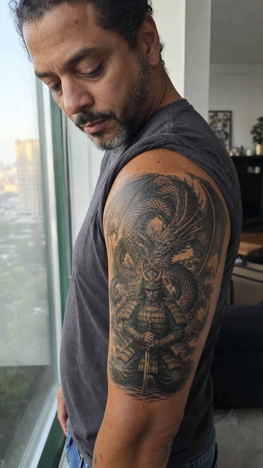 Unlock Your Next Ink: 25 Epic Upper Arm Tattoo Ideas for Men 50 Healed samurai dragon tattoo on a adult man's outer upper arm, photographed in a natural slightly elevated close view — study 2