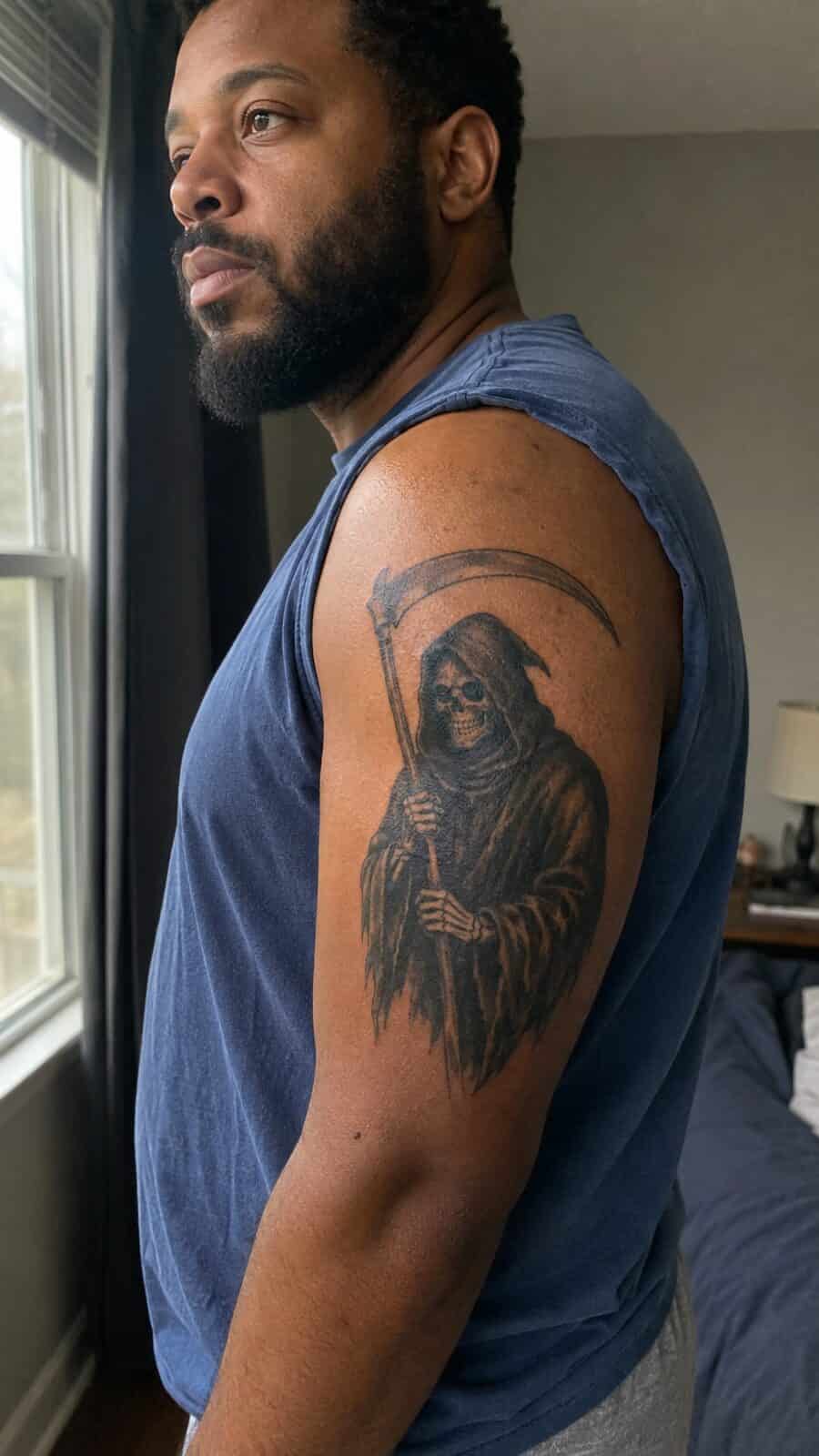 Unlock Your Next Ink: 25 Epic Upper Arm Tattoo Ideas for Men 55 Healed grim reaper with scythe tattoo on a adult man's outer upper arm, photographed in a natural gentle side angle that clearly shows — study 2