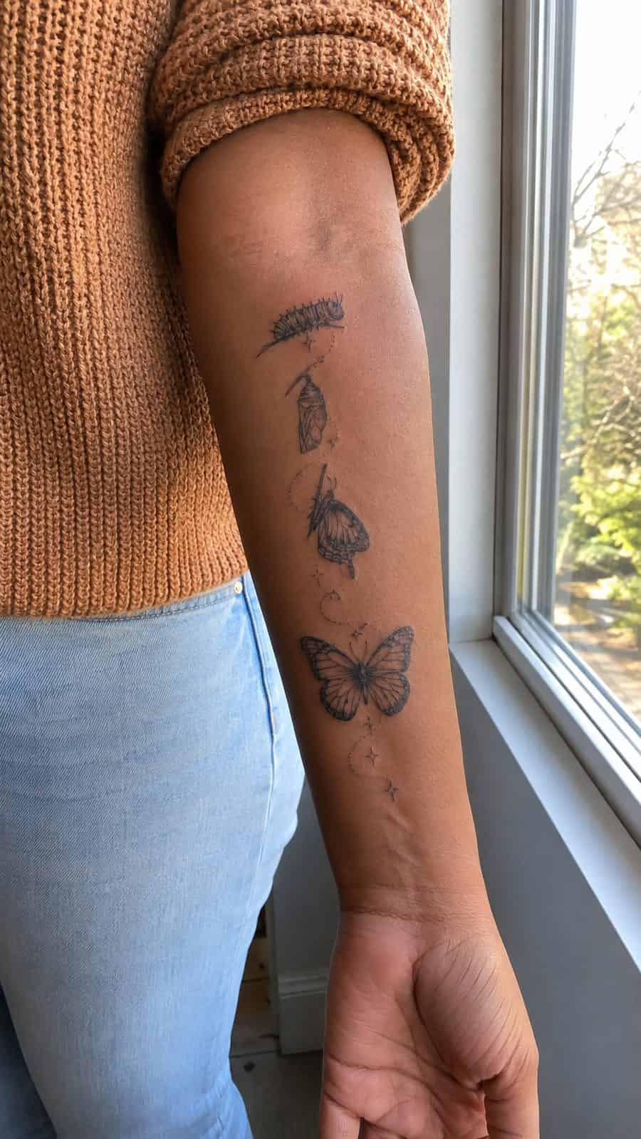 35 Forearm Tattoos for Women Worth Considering 17 Healed butterfly metamorphosis tattoo on a adult woman's inner forearm, photographed in a natural waist-height candid close-up — study 1