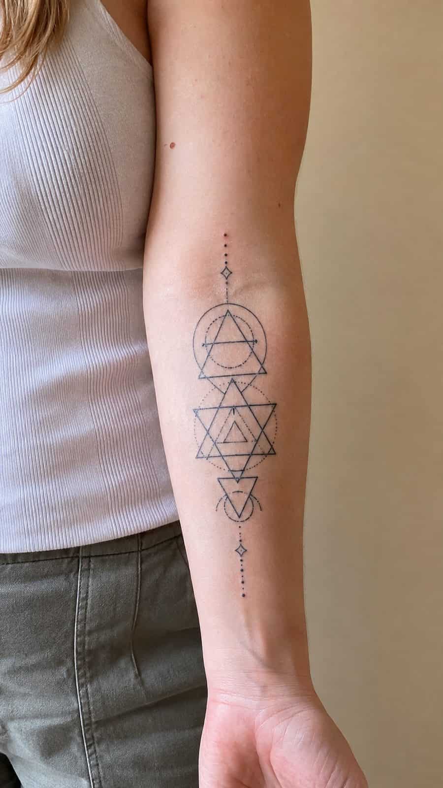 35 Forearm Tattoos for Women Worth Considering 26 Healed geometric harmony tattoo on a adult woman's inner forearm, photographed in a natural casual close three-quarter view — study 3