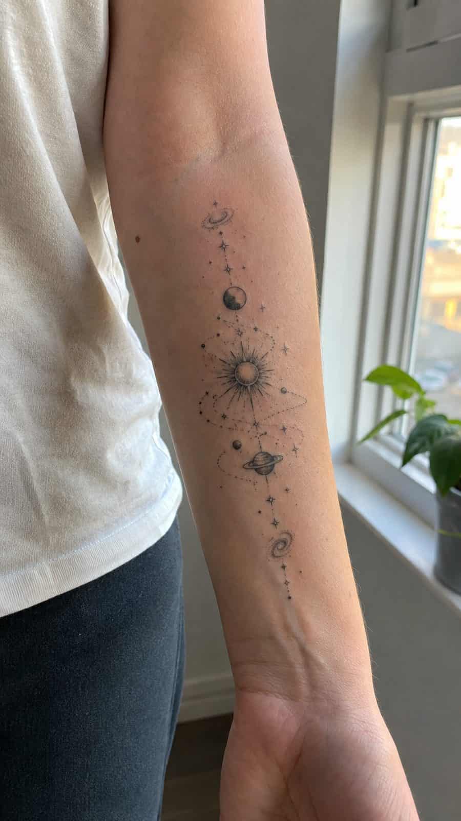 35 Forearm Tattoos for Women Worth Considering 29 Healed cosmic connection tattoo on a adult woman's inner forearm, photographed in a natural relaxed documentary crop — study 1