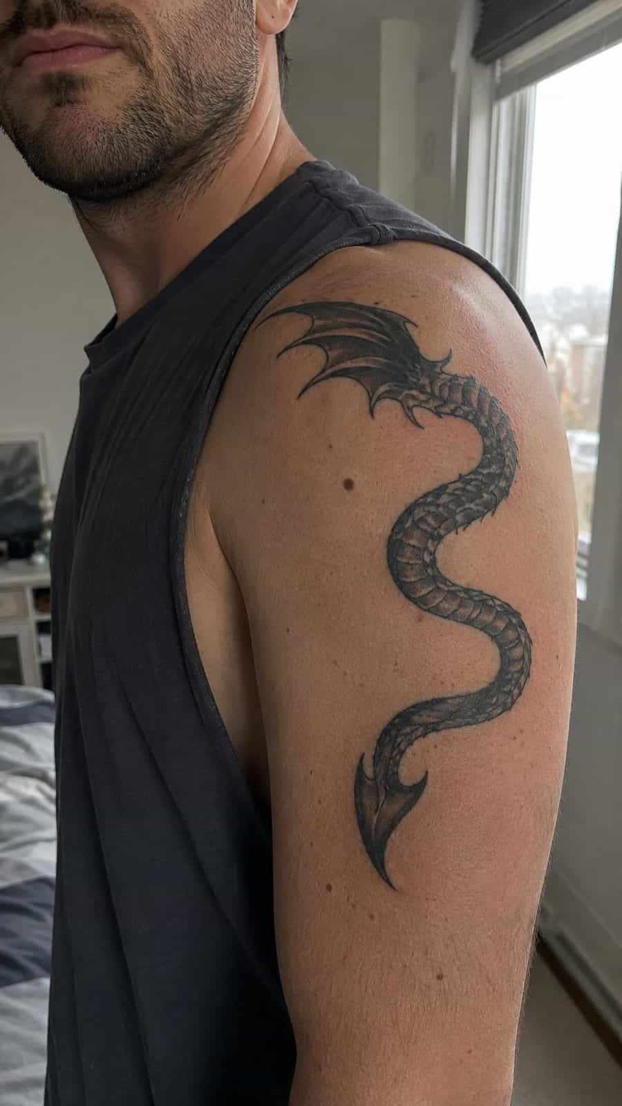 Unleash Your Dark Side: 23 Devilishly Unique Tattoo Ideas for Men 10 Healed serpentine devil tail tattoo on a adult man's shoulder, photographed in a natural straight-on close view, a touch off-center — study 2