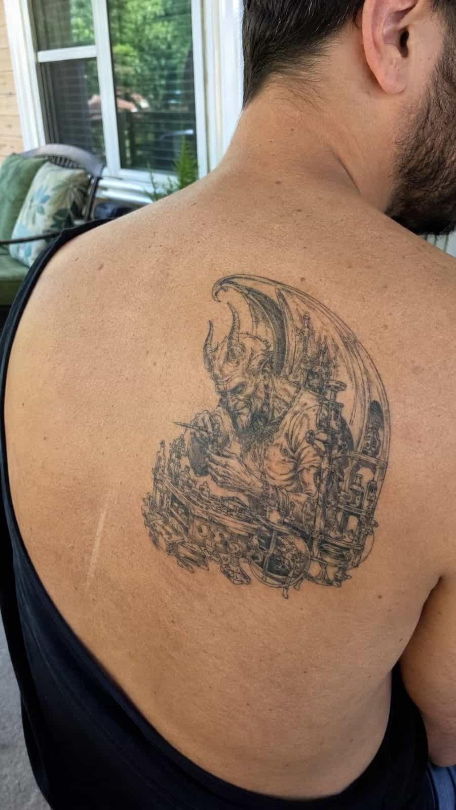 Unleash Your Dark Side: 23 Devilishly Unique Tattoo Ideas for Men 18 Healed devil in the details tattoo on a adult man's upper back, photographed in a natural gentle side angle that clearly shows how the — study 1