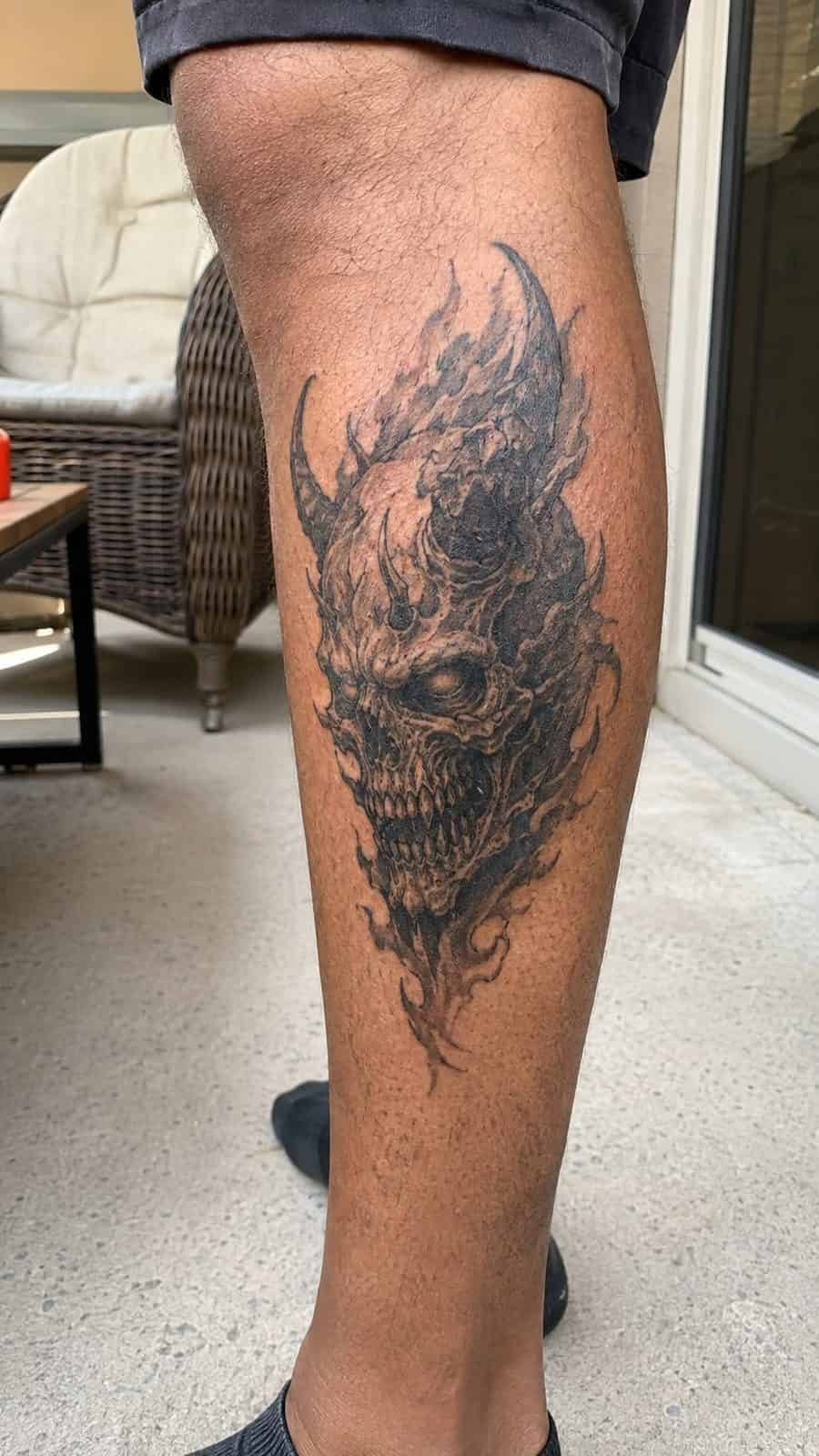 Unleash Your Dark Side: 23 Devilishly Unique Tattoo Ideas for Men 21 Healed demonic skull tattoo on a adult man's outer calf, photographed in a natural slightly elevated close view — study 1