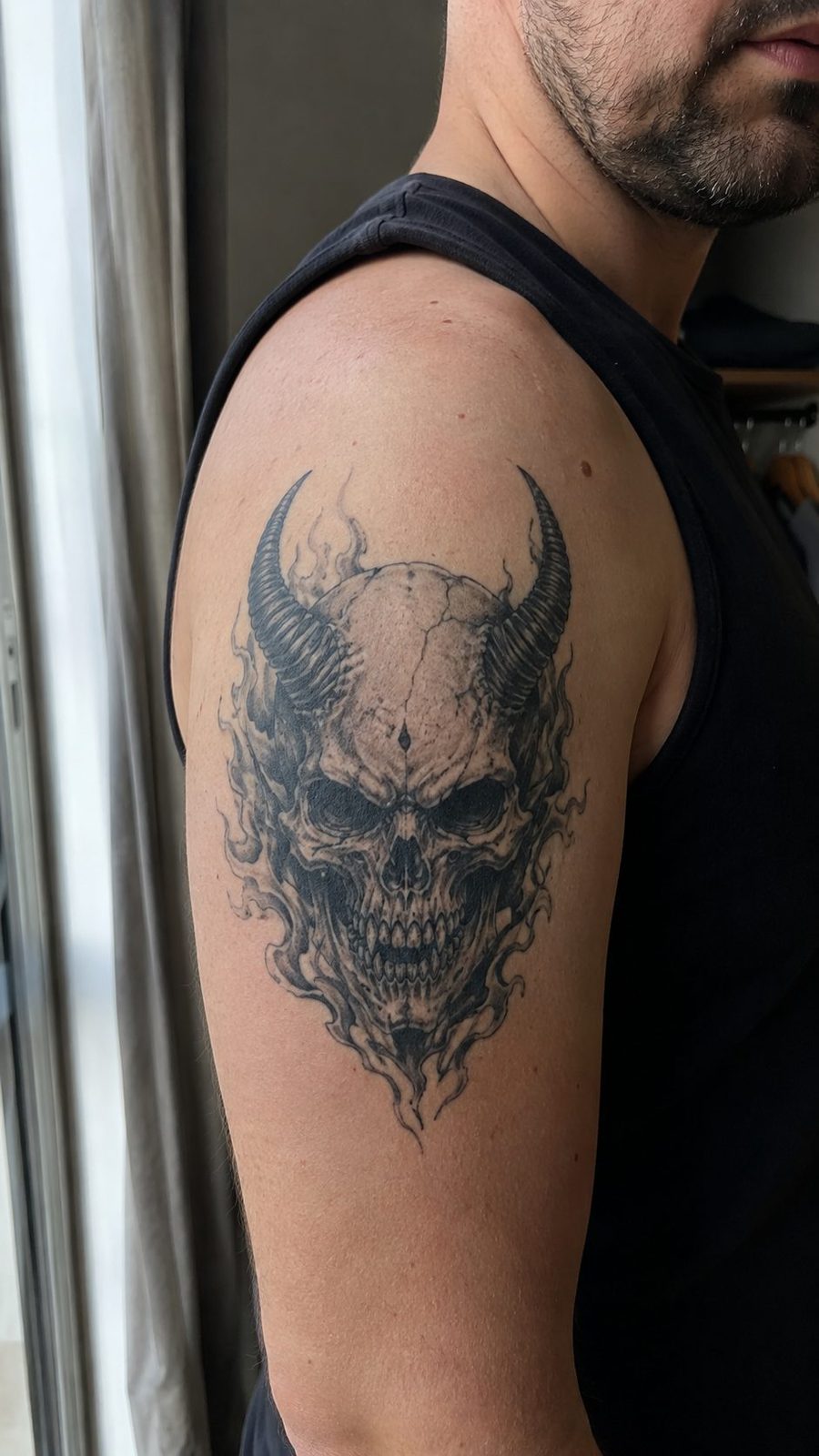 Unleash Your Dark Side: 23 Devilishly Unique Tattoo Ideas for Men 23 Healed demonic skull tattoo on a adult man's outer upper arm, photographed in a natural relaxed documentary crop — study 3