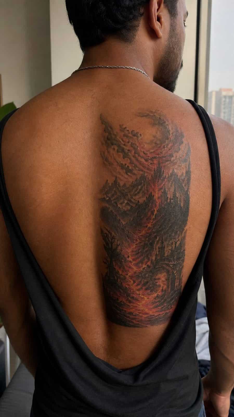 Unleash Your Dark Side: 23 Devilishly Unique Tattoo Ideas for Men 26 Healed inferno landscape tattoo on a adult man's upper back, photographed in a natural gentle side angle that clearly shows how the — study 1