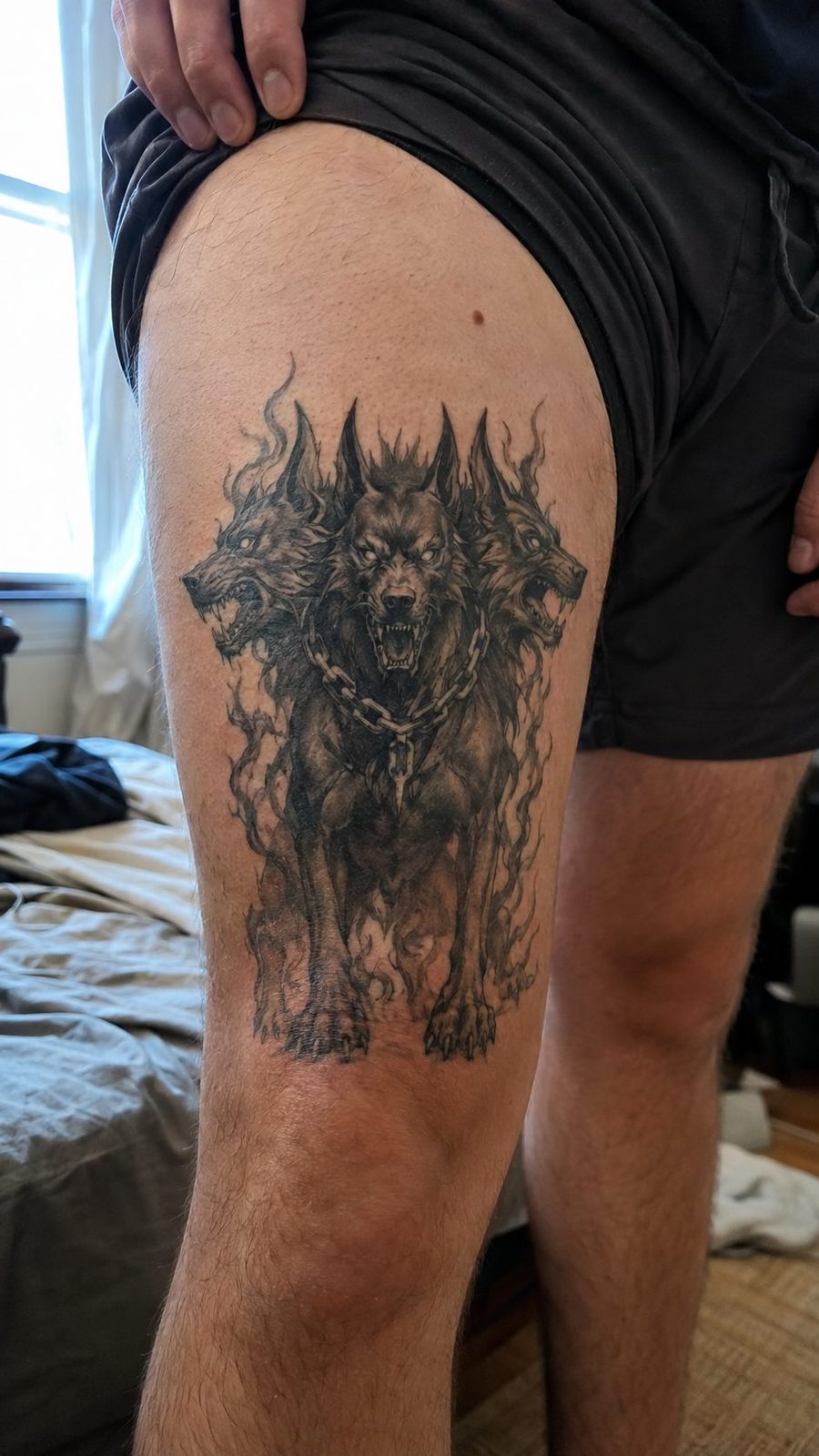 Unleash Your Dark Side: 23 Devilishly Unique Tattoo Ideas for Men 32 Healed hellhound companion tattoo on a adult man's outer thigh, photographed in a natural casual close three-quarter view — study 1