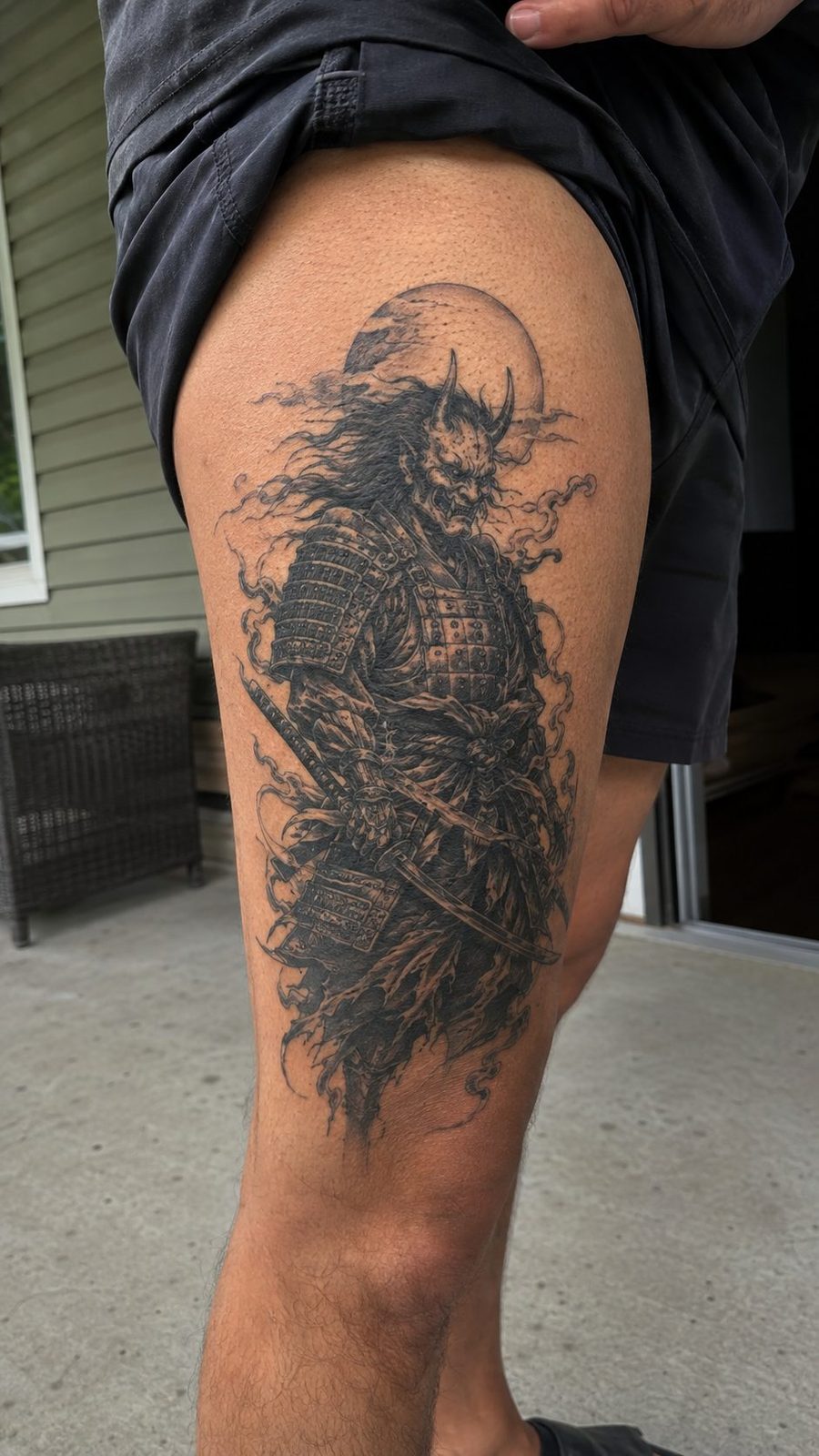 Unleash Your Dark Side: 23 Devilishly Unique Tattoo Ideas for Men 40 Healed devilish samurai tattoo on a adult man's outer thigh, photographed in a natural waist-height candid close-up — study 1