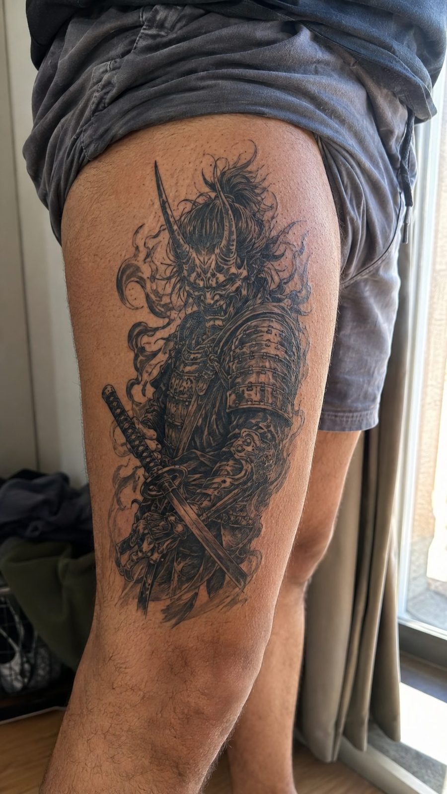 Unleash Your Dark Side: 23 Devilishly Unique Tattoo Ideas for Men 42 Healed devilish samurai tattoo on a adult man's outer thigh, photographed in a natural casual close three-quarter view — study 3