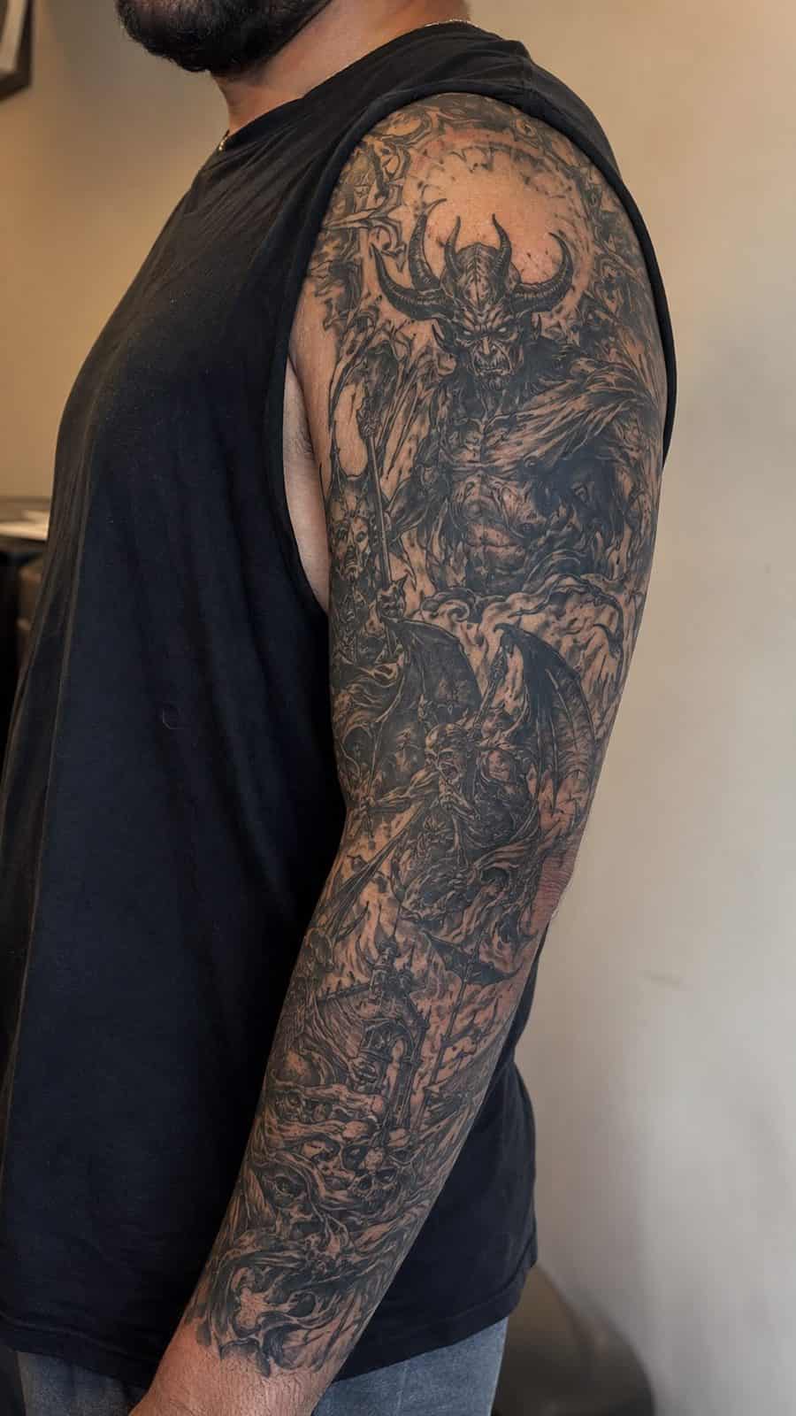 Unleash Your Dark Side: 23 Devilishly Unique Tattoo Ideas for Men 50 Healed fiendish full sleeve tattoo on a adult man's upper-arm sleeve, photographed in a natural gentle side angle that clearly shows — study 1