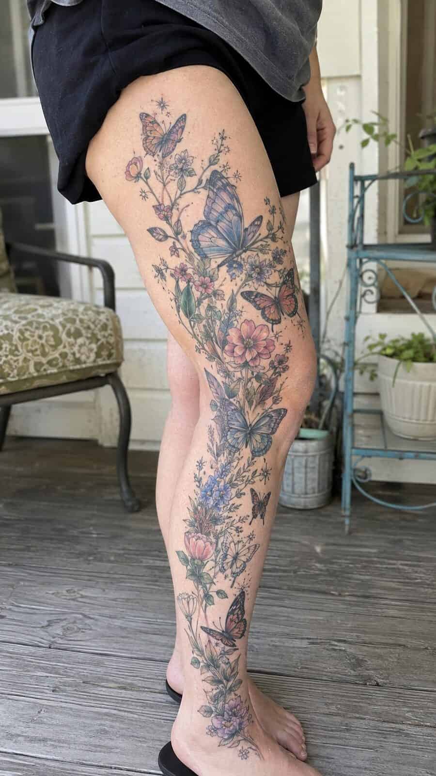 32 Gorgeous Female Leg Sleeve Tattoos 9 Healed ethereal butterfly garden tattoo on a adult woman's full outer leg sleeve, photographed in a natural straight-on close view, a — study 1