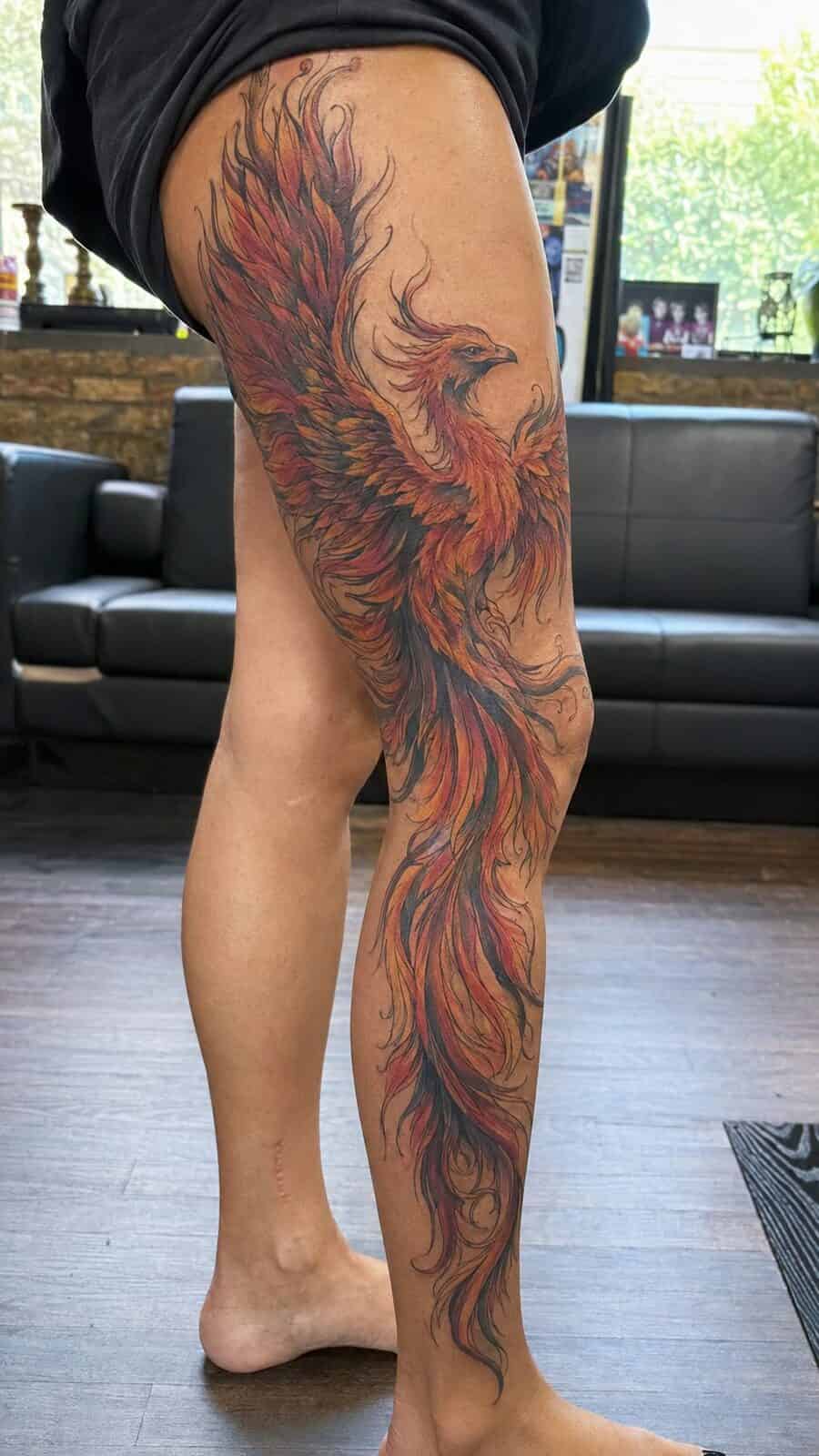 32 Gorgeous Female Leg Sleeve Tattoos 16 Healed majestic phoenix rising tattoo on a adult woman's full outer leg sleeve, photographed in a natural relaxed documentary crop — study 1