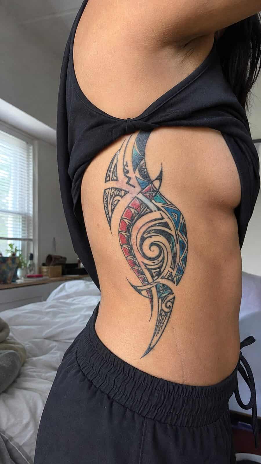 32 Gorgeous Female Leg Sleeve Tattoos 34 Healed vibrant tribal fusion tattoo on a adult woman's side ribs, photographed in a natural slightly elevated close view — study 1
