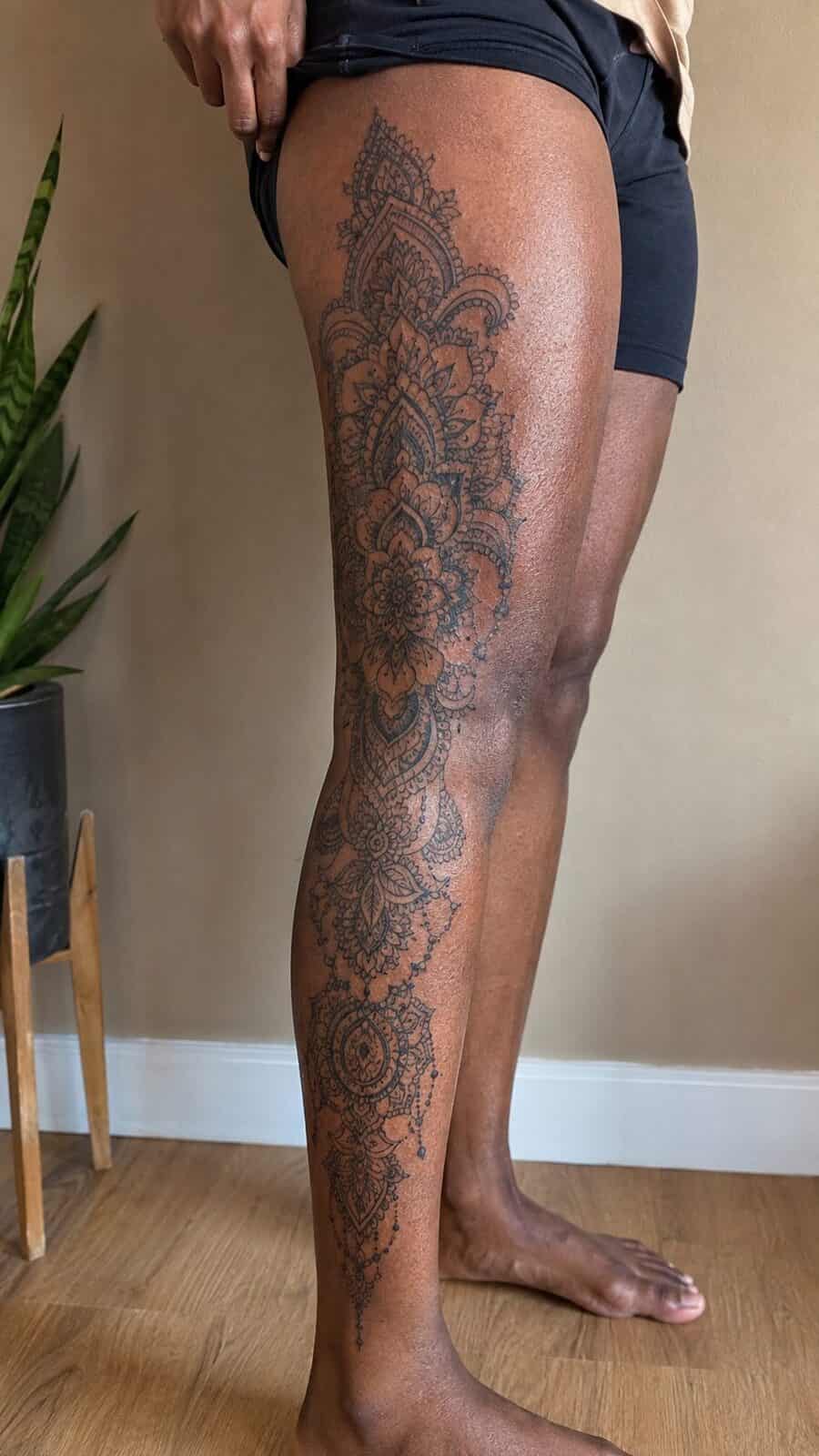 32 Gorgeous Female Leg Sleeve Tattoos 38 Healed intricate henna-inspired art tattoo on a adult woman's full outer leg sleeve, photographed in a natural waist-height candid — study 1