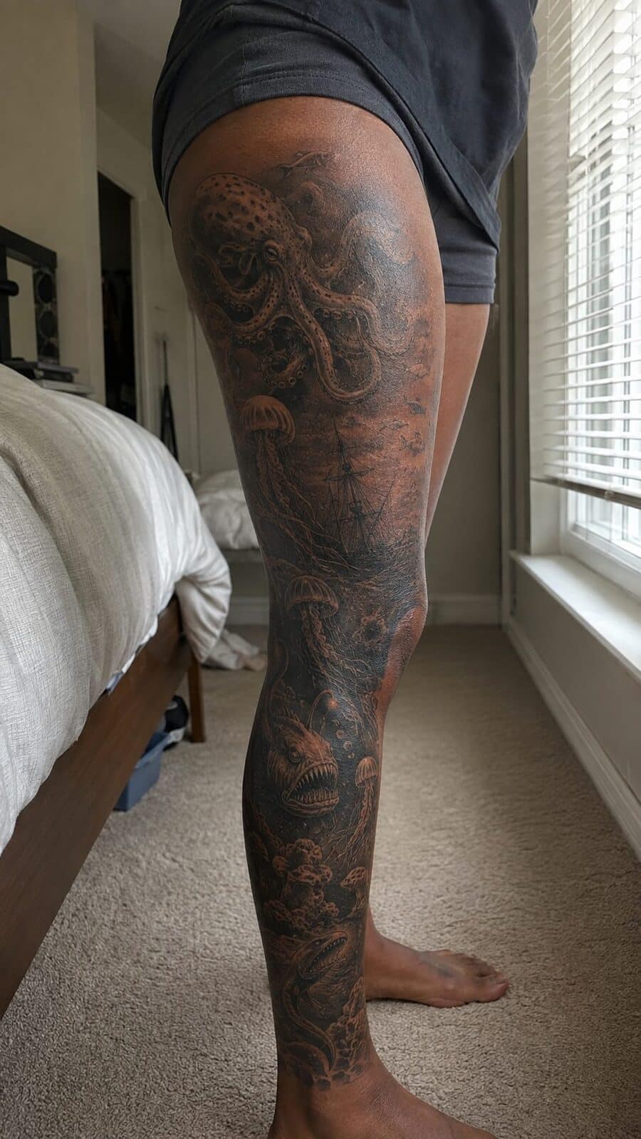 32 Gorgeous Female Leg Sleeve Tattoos 45 Healed mystery of the deep ocean tattoo on a adult woman's full outer leg sleeve, photographed in a natural waist-height candid — study 1