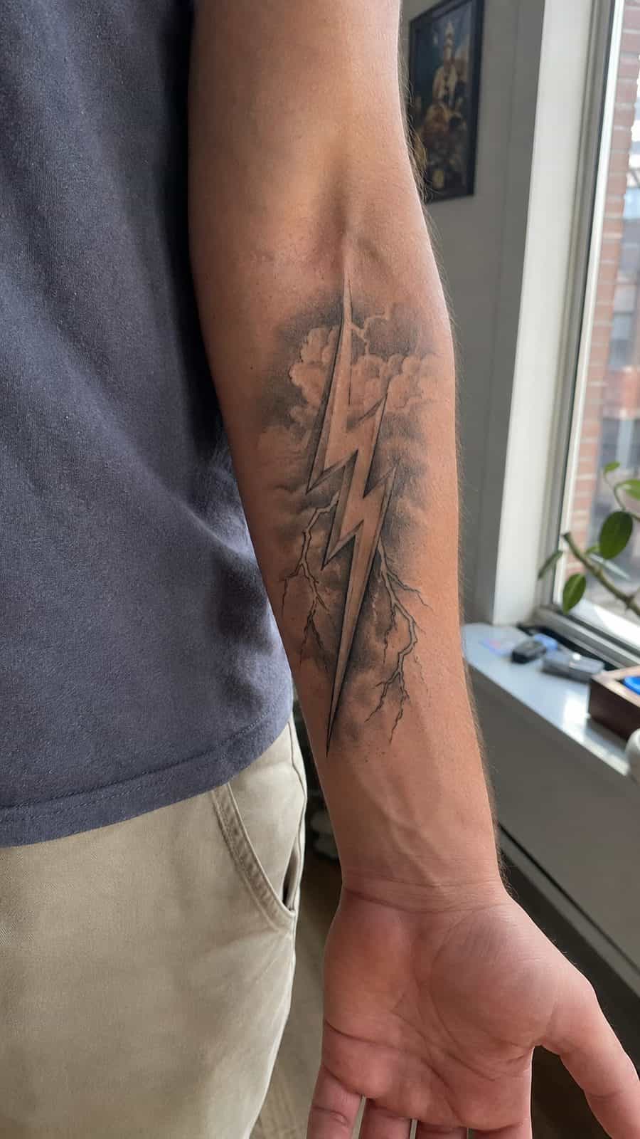 Modern Spartan: 18 Greek Tattoo Ideas Every Man Should Consider 3 Healed zeus's thunderbolt tattoo on a adult man's inner forearm, photographed in a natural waist-height candid close-up — study 2