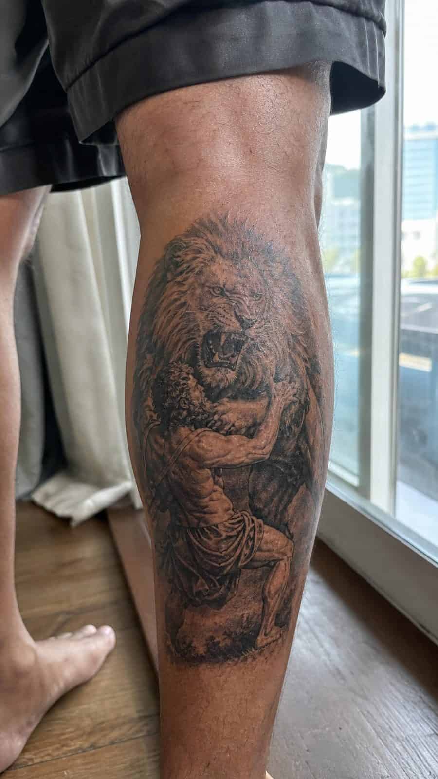Modern Spartan: 18 Greek Tattoo Ideas Every Man Should Consider 13 Healed hercules's lion tattoo on a adult man's outer calf, photographed in a natural slightly elevated close view — study 2