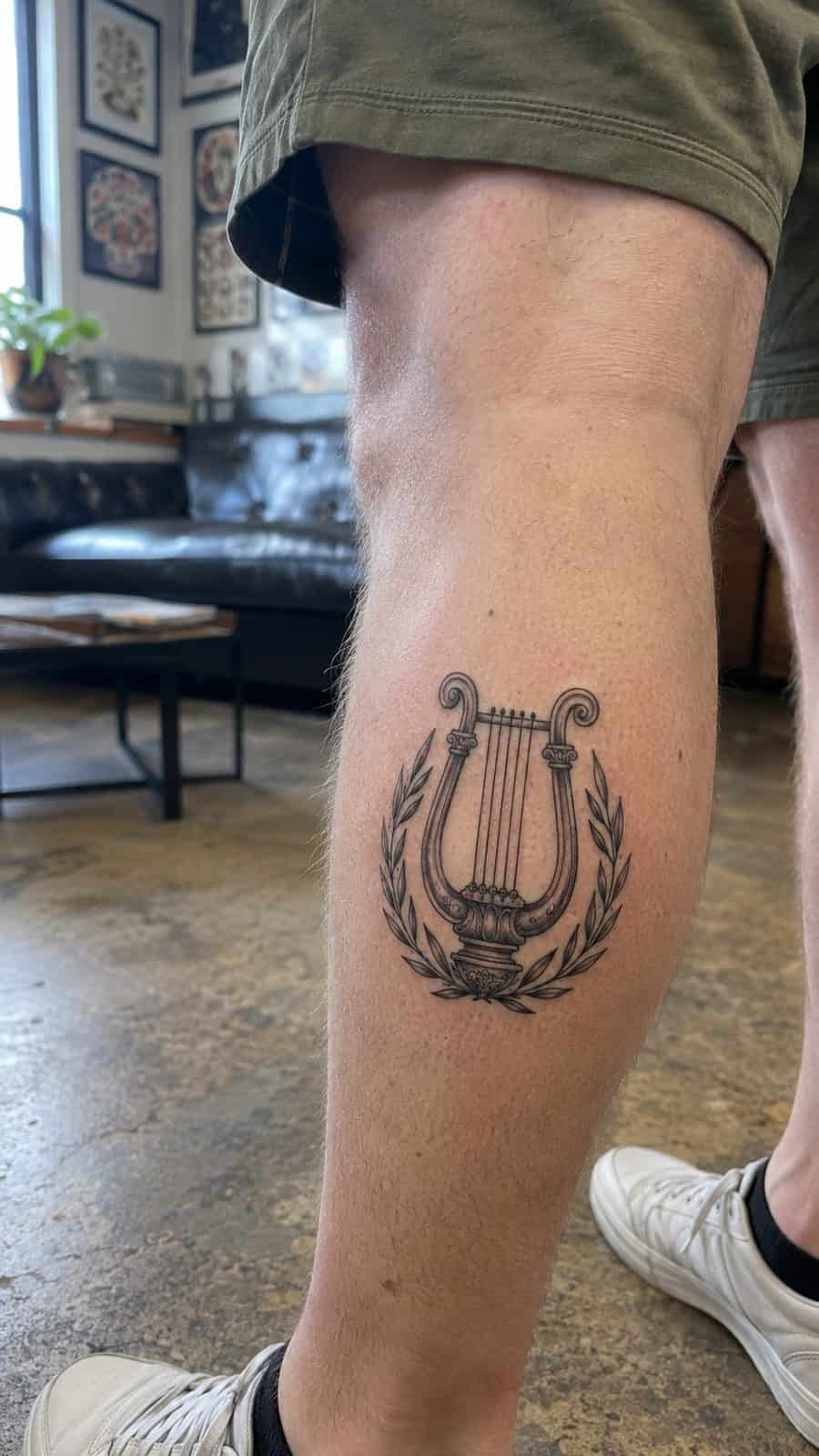 Modern Spartan: 18 Greek Tattoo Ideas Every Man Should Consider 16 Healed apollo's lyre tattoo on a adult man's outer calf, photographed in a natural casual close three-quarter view — study 1
