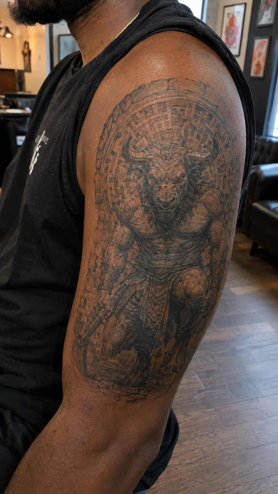 Modern Spartan: 18 Greek Tattoo Ideas Every Man Should Consider 22 Healed the minotaur tattoo on a adult man's outer upper arm, photographed in a natural waist-height candid close-up — study 2