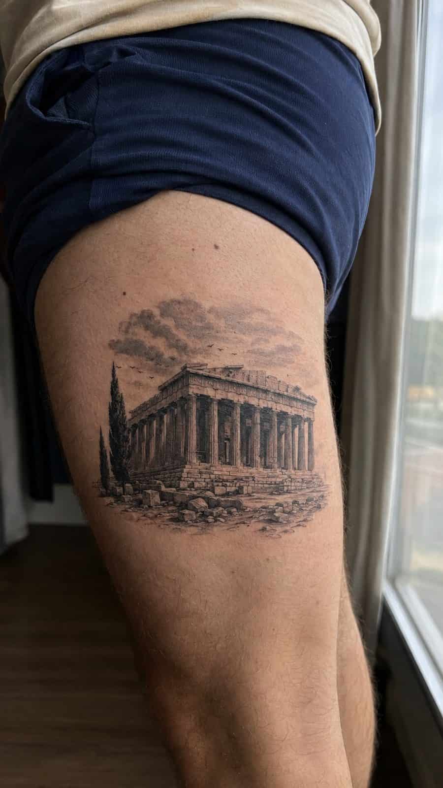 Modern Spartan: 18 Greek Tattoo Ideas Every Man Should Consider 25 Healed the parthenon tattoo on a adult man's outer thigh, photographed in a natural casual close three-quarter view — study 2
