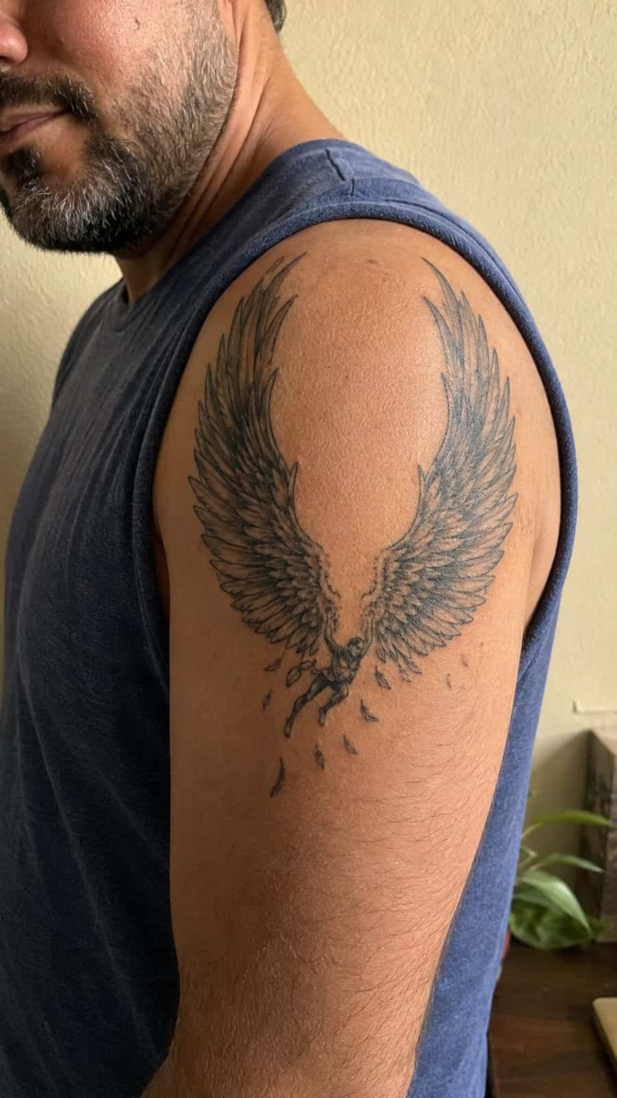 Modern Spartan: 18 Greek Tattoo Ideas Every Man Should Consider 29 Healed icarus's wings tattoo on a adult man's shoulder, photographed in a natural casual close three-quarter view — study 1