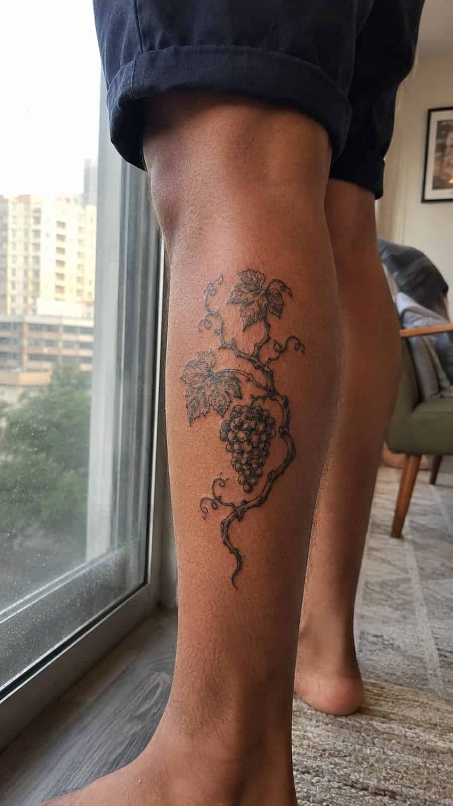 Modern Spartan: 18 Greek Tattoo Ideas Every Man Should Consider 34 Healed dionysus's grapevine tattoo on a adult man's outer calf, photographed in a natural waist-height candid close-up — study 2