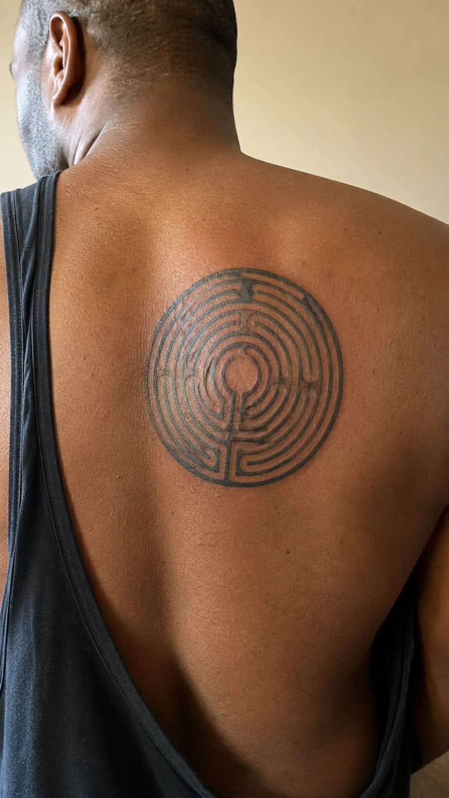 Modern Spartan: 18 Greek Tattoo Ideas Every Man Should Consider 38 Healed the labyrinth tattoo on a adult man's upper back, photographed in a natural straight-on close view, a touch off-center like a — study 1
